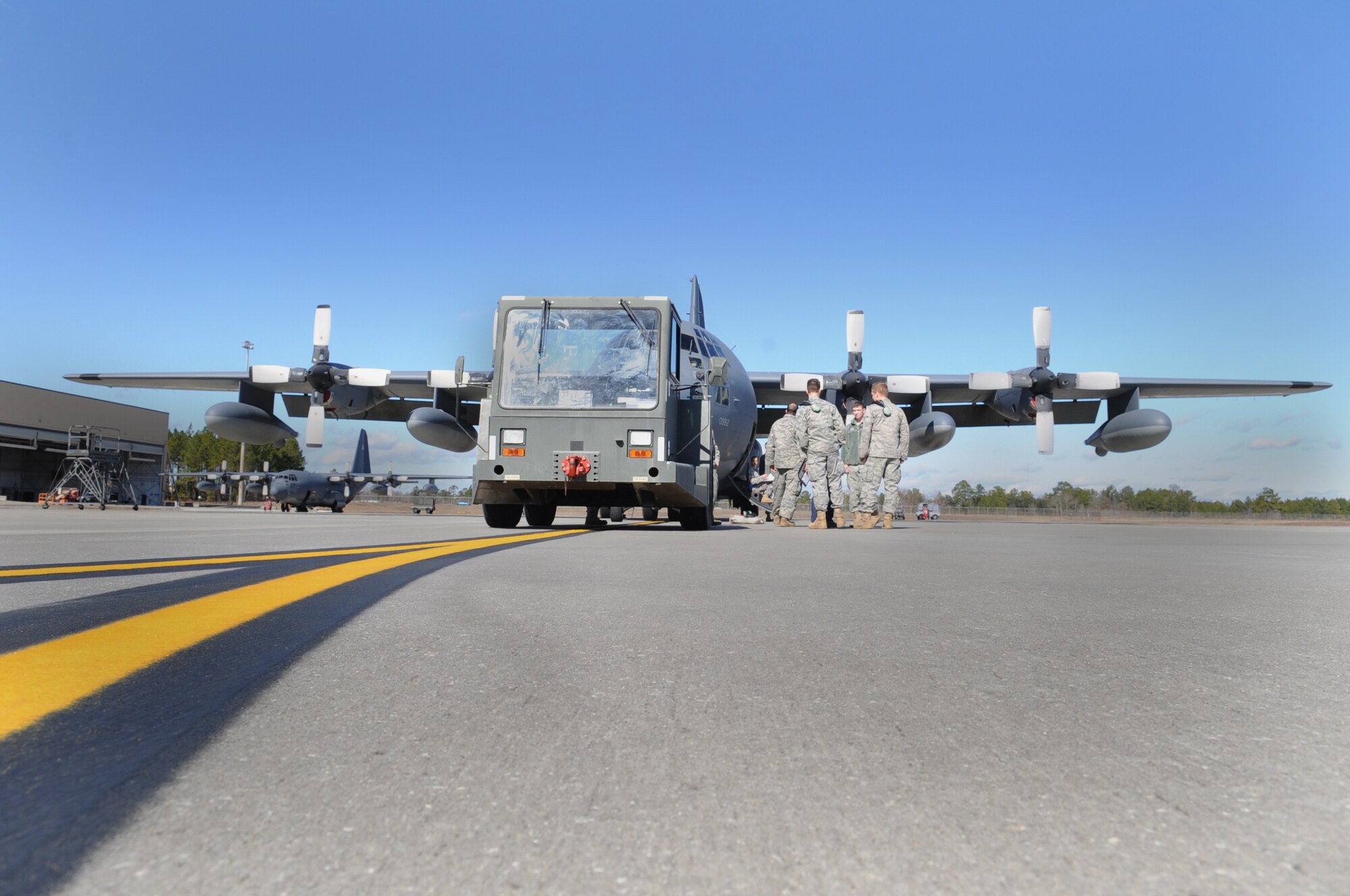 MOODY AIR FORCE BASE, Ga. -- Members of the 71st Aircraft Maintenance Unit prepare to tow a HC-130P Combat King Jan. 26. The 71st AMU used a MB-2 tow tractor to tow the recently de-fueled HC-130P. (U.S. Air Force photo/Airman 1st Class Douglas Ellis)(RELEASED)
