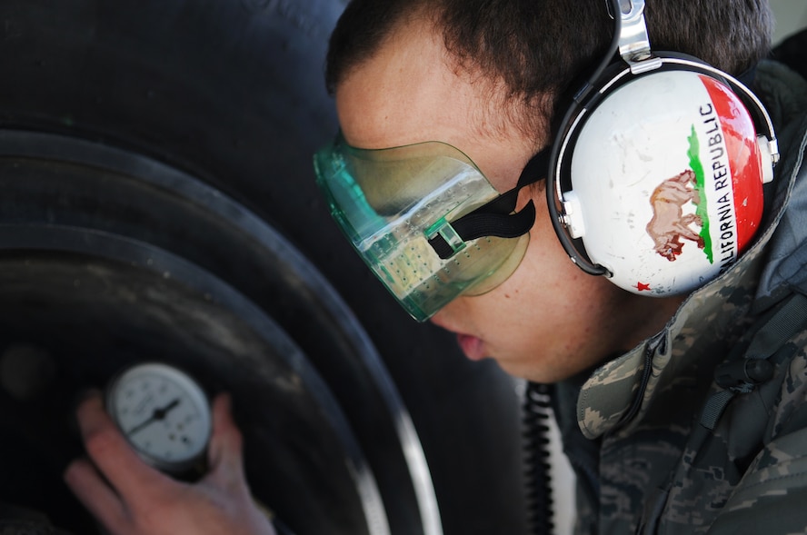 MOODY AIR FORCE BASE, Ga. -- Senior Airman Anton Coleman, 71st Aircraft Maintenance Unit crew chief, checks the tire pressure of a HC-130P Combat King Jan. 26. Proper tire pressure is required to help prevent the tire from exploding. (U.S. Air Force photo/Airman 1st Class Douglas Ellis)(RELEASED)
