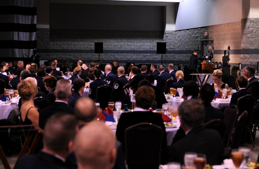 VALDOSTA, Ga.-- Military members, spouses and civic leaders watch as a member of the Moody Air Force Base Honor Guard places a flag on the Fallen Warrior Memorial during the Annual Awards Banquet Jan.29. Nearly 500 people attended the banquet to support the nominees. (U.S. Air Force photo/Airman 1st Class Benjamin Wiseman)(RELEASED)