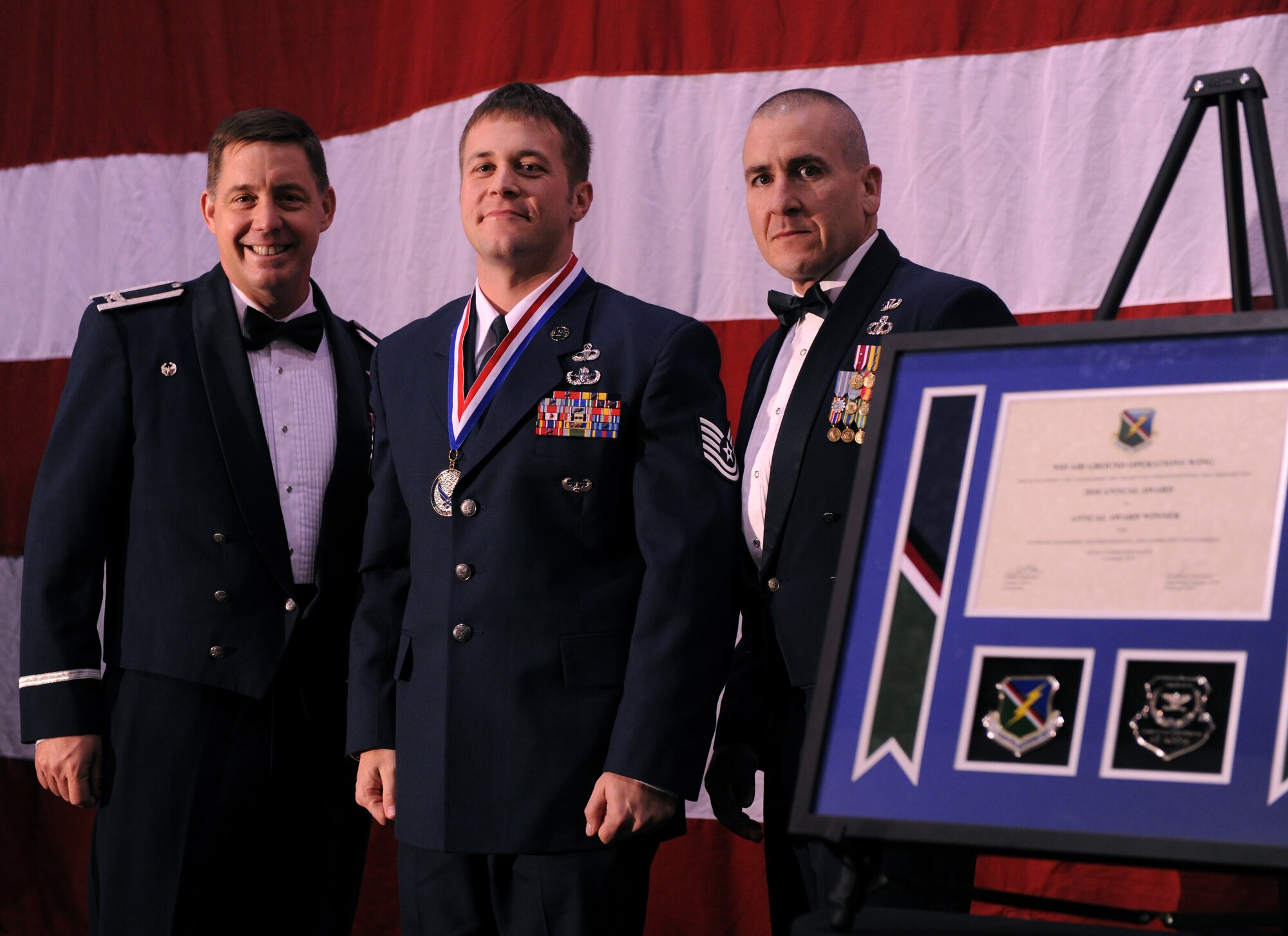 VALDOSTA, Ga.-- Tech. Sgt. Jeremy Phillips, 93rd Air Ground Operations Wing NCO nominee, poses with Col. John Horner, 93rd AGOW commander, and Chief Master Sgt.  Nick Vallely, 93rd AGOW command chief, after receiving the annual award for the 93rd AGOW NCO category Jan. 29. Sergeant Phillips beat out three other nominees to receive the award for being the highest performing NCO during 2010. (U.S. Air Force photo/Airman 1st Class Benjamin Wiseman)(RELEASED)
