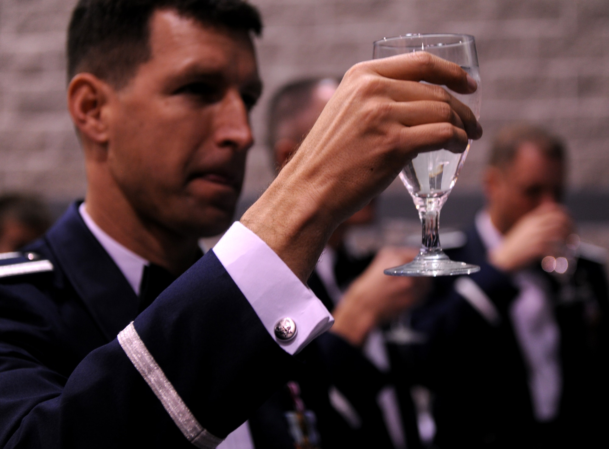 VALDOSTA, Ga.-- Lt. Col. Andrew Reisenweber, 58th Rescue Squadron commander, Nellis Air Force Base, Nev., raises a glass of water as a toast to fallen warriors during the Annual Awards Banquet Jan. 29. Colonel Reisenweber came to support his Airmen during the Annual Awards Banquet. (U.S. Air Force photo/Airman 1st Class Benjamin Wiseman)(RELEASED)