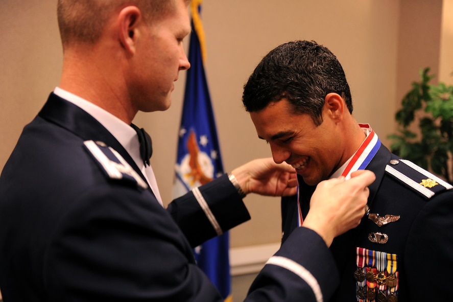 VALDOSTA, Ga.-- Maj. Jose Cabrera, 23rd Wing field grade officer annual award nominee, receives a medallion from Col. Gary Henderson, 23rd WG commander, during the medallion ceremony as part of the Annual Awards Banquet held at the James H. Rainwater Conference Center Jan. 29. There were several nominees in each category, but only one was chosen as the annual award winner. (U.S. Air Force photo/Airman 1st Class Benjamin Wiseman)(RELEASED)