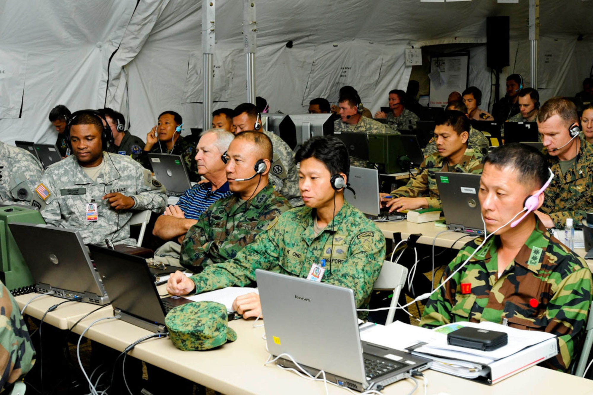 Service members from Indonesia, Japan, Republic of Korea, Singapore, Thailand and the U.S., use a distributed communications system called Defense Connect Online at the training contingency command post during Cobra Gold, regularly scheduled joint and multinational exercise hosted annually by the Kingdom of Thailand. This year marks the 30th anniversary for the exercise, which consists of a Global Peacekeeping Operations Initiative Exercise, Command Post Exercise, Humanitarian Civic Assistance projects and field training exercises. (U.S. Army photo/Spc. Lyndsey R. Dransfield)
