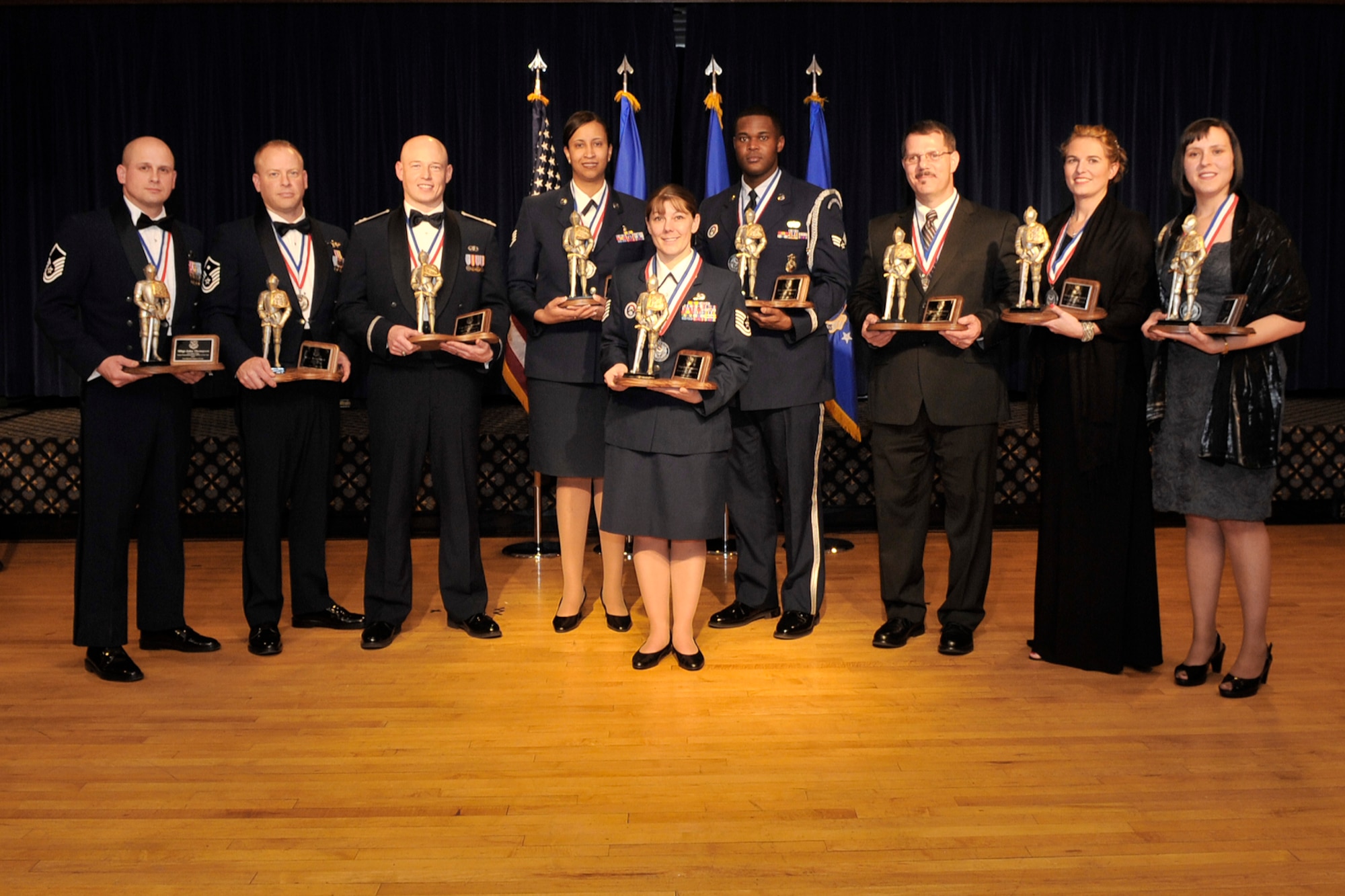 PETERSON AIR FORCE BASE, Colo. – Airmen and civilians were honored for their good work Jan. 27 at the 2010 21st Space Wing Annual Awards banquet at The Club. 
Winners in attendance, from left:
•	Senior Non Commissioned Officer winner, Master Sgt. John Thompson
•	First Sergeant winner, Master Sgt. David Pesch
•	Company Grade Officer winner, Capt. Jesse Johnson
•	Non Commissioned Office winner, Staff Sgt. Monisha Barnes
•	High Frontier Honor Guard Non Commissioned Officer winner, Tech. Sgt. Sue Thompson
•	High Frontier Honor Guard Airman winner, Senior Airman Lee Hammonds
•	Civilian CAT II non-supervisory winner Michael Puleo
•	Civilian CAT I winner, Cindy Varnes-Wooley
•	Civilian CAT II supervisory winner Joey Sanchez. 
Those not in attendance:
•	Volunteer Excellence winner, Theresa Lewandowski-VanEtta
•	Field Grad Officer winner, Maj. Assad Samad
•	Airman winner Senior Airman Louis Vassoler
•	Civilian CAT I Non-Supervisory winner, Chelsea Owens 
(U.S. Air Force photo/Rob L. Bussard)
