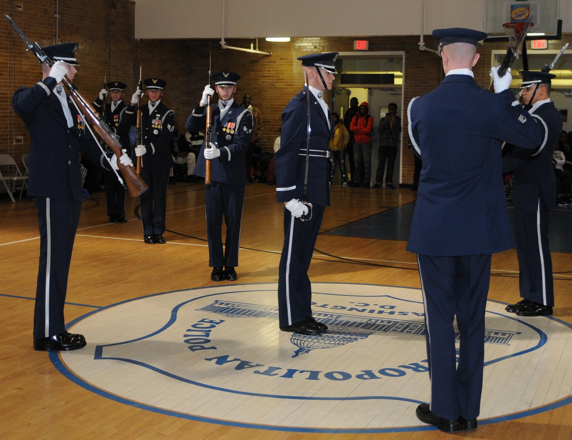 Capt. Chad Frey, U.S. Air Force Honor Guard drill team commander, stands in the center of the drill team’s performance Jan 21 at the Boys and Girls Club of D.C., Washington D.C. The USAF Honor Guard performs in the local community to raise awareness of the Air Force mission. (U.S. Air Force photo by Senior Airman Christopher Ruano)