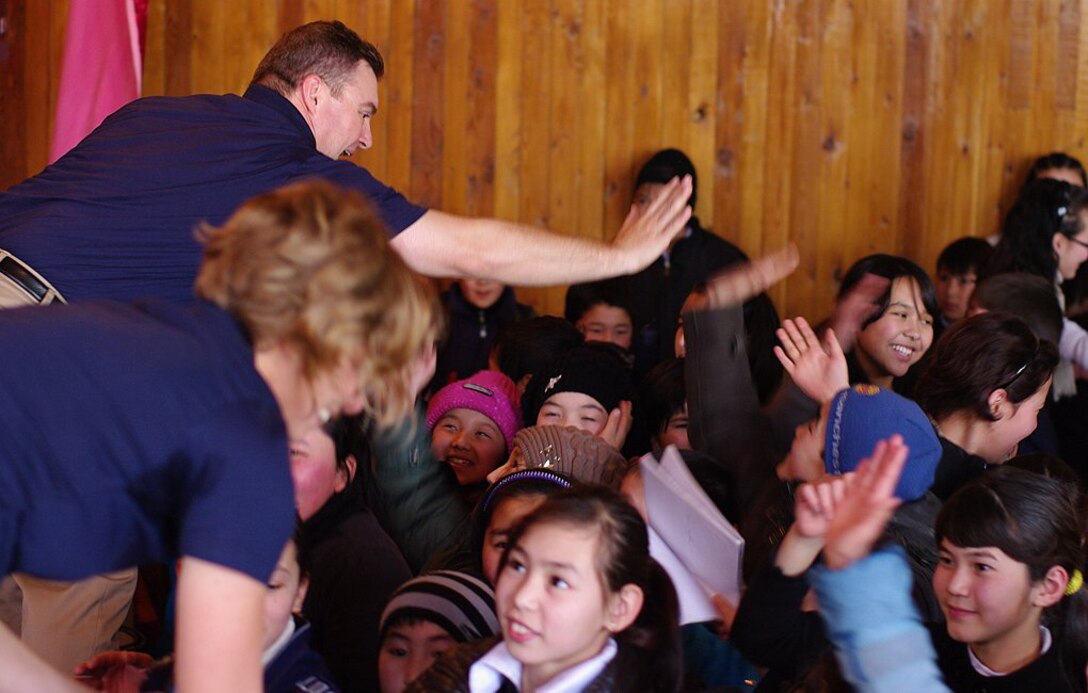 TSgt Jamie Gilley gives a high five to students at the Shubin School of Music in Bishkek, Kyrgyzstan.
