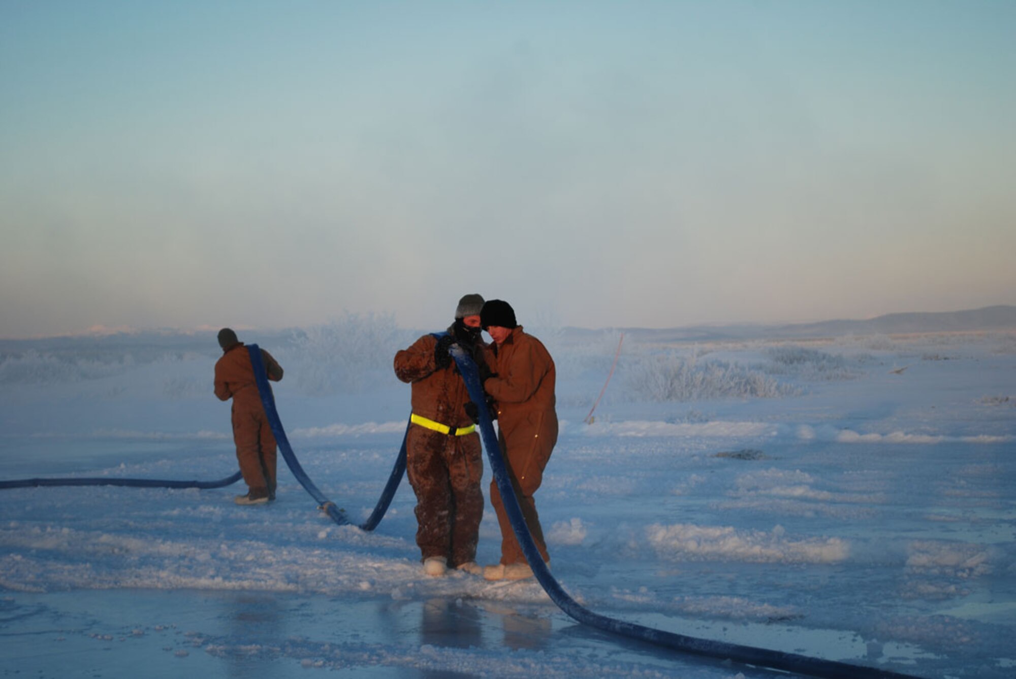 Soldiers from the 6th Engineer Battalion, Fort Richardson, Alaska, clear water lines during construction of an ice bridge at the U.S. Army Cold Regions Test Center at Fort Greely, Alaska, Jan. 12. (Courtesy photo)