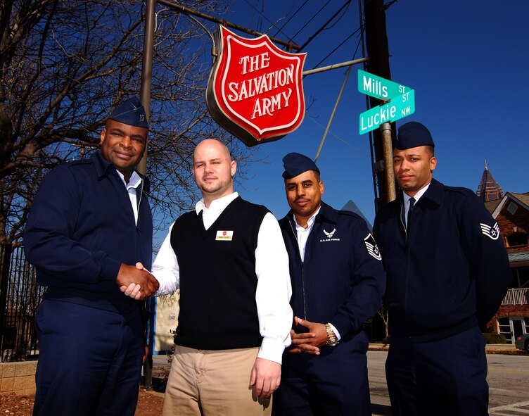 Atlanta Salvation Army representative Harry Clark thanks Capt. Darrell Bogan along with Master Sgt. Murray Taylor and Staff Sgt. Richard Conyers for the food and clothing donation from personnel of the 94th Airlift Wing, Dobbins Air Reserve Base, Ga., Jan 24.  The items collected during the first-ever Dobbins Human Resource Development Council food and clothing drive were part of an overall donation to multiple area charities.  (U.S. Air Force photo/ Brad Fallin)