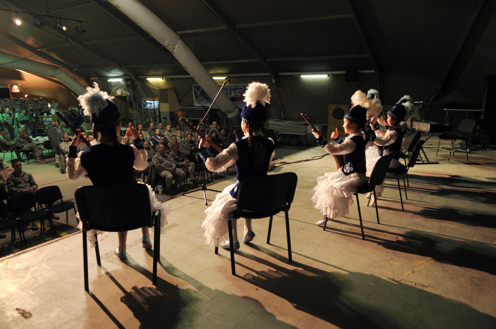 TRANSIT CENTER AT MANAS, Kyrgyzstan -  Students from the Musical School for Gifted Kids skillfully play their Komuz, a traditional Kyrgyz instrument. The students showcased their talents for the Transit Center service members during a concert 31 Jan. (U.S. Air Force photo/Staff Sgt. Stacy Moless).(U.S. Air Force photo/Staff Sgt. Stacy Moless)
