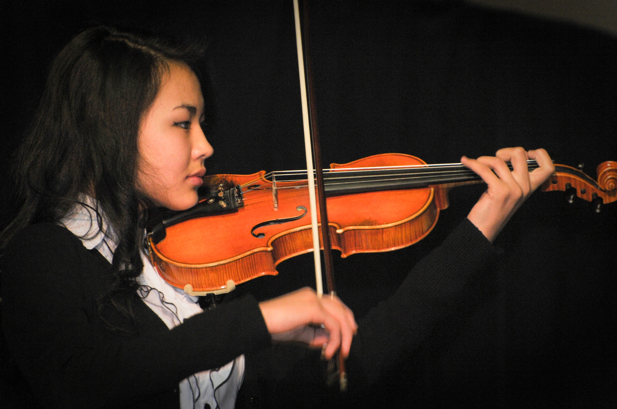 TRANSIT CENTER AT MANAS, Kyrgyzstan -  A Student from the Musical School for Gifted Kids skillfully plays her violin. The students showcased their talents for the Transit Center service members during a concert 31 Jan. (U.S. Air Force photo/Staff Sgt. Stacy Moless).(U.S. Air Force photo/Staff Sgt. Stacy Moless)