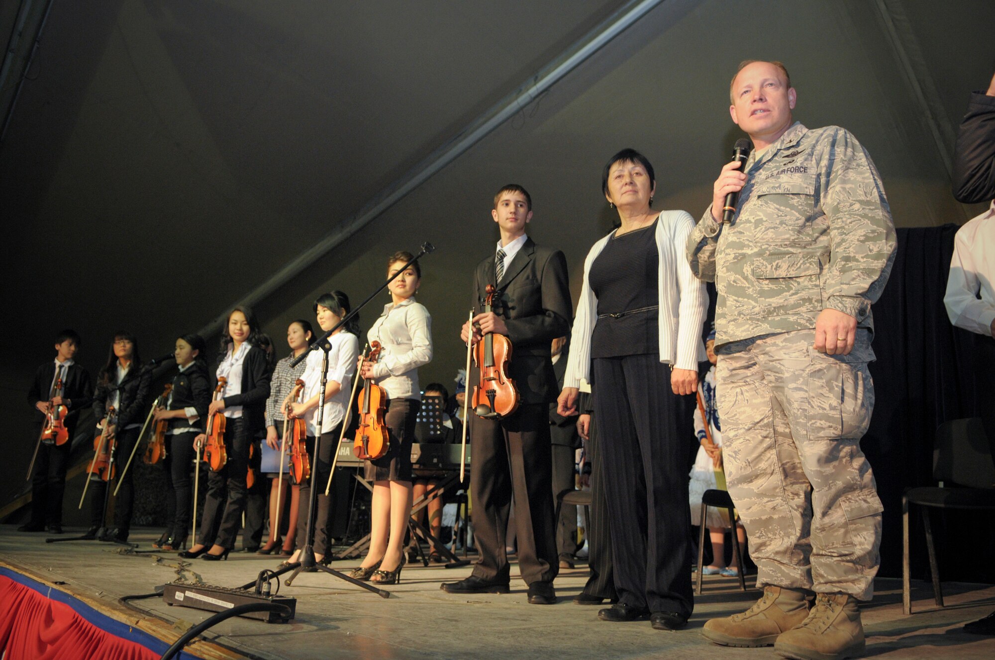 TRANSIT CENTER AT MANAS, Kyrgyzstan -  Col. Brian Brandner, Vice Commander of the Transit Center at Manas introduces the children from the Musical School for Gifted Kids. The students showcased their talents for the Transit Center service members during a concert 31 Jan. (U.S. Air Force photo/Staff Sgt. Stacy Moless).(U.S. Air Force photo/Staff Sgt. Stacy Moless)
