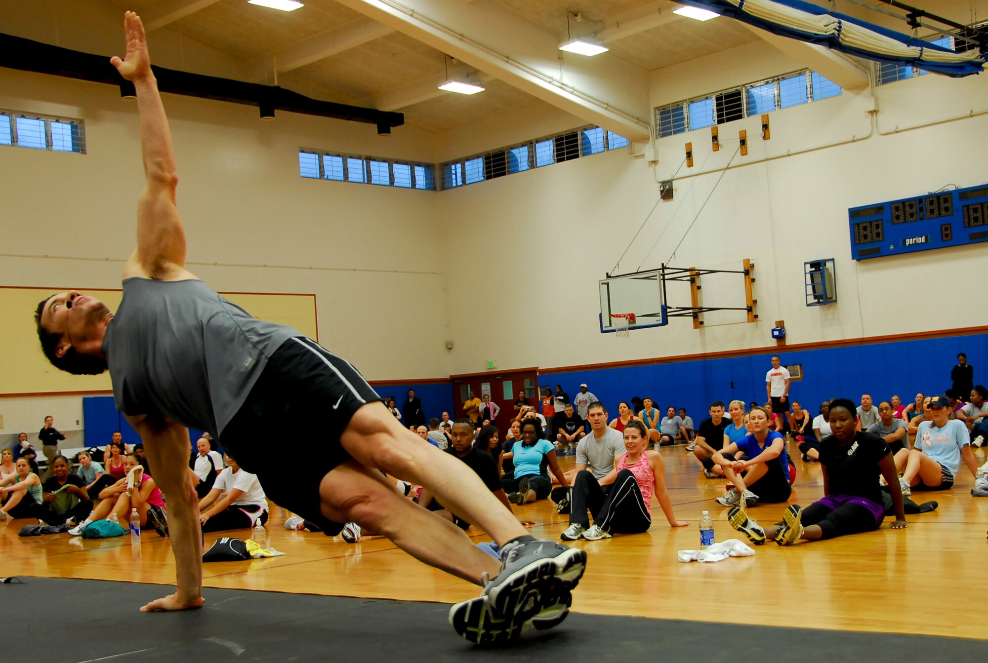 Tony Horton, creator of the fitness program, P90X, demonstrates an exercise routine for participants attending the fitness clinic in Kadena’s Risner Fitness Center, Jan. 29. As part of the Armed Forces Entertainment’s “Ripped and Ready Tour,” Mr. Horton has been visiting U.S. military bases across the U.S., Italy and now Japan to promote physical fitness for service members and their families. (U.S. Air Force photo/ Airman 1st Class Maeson L. Elleman)