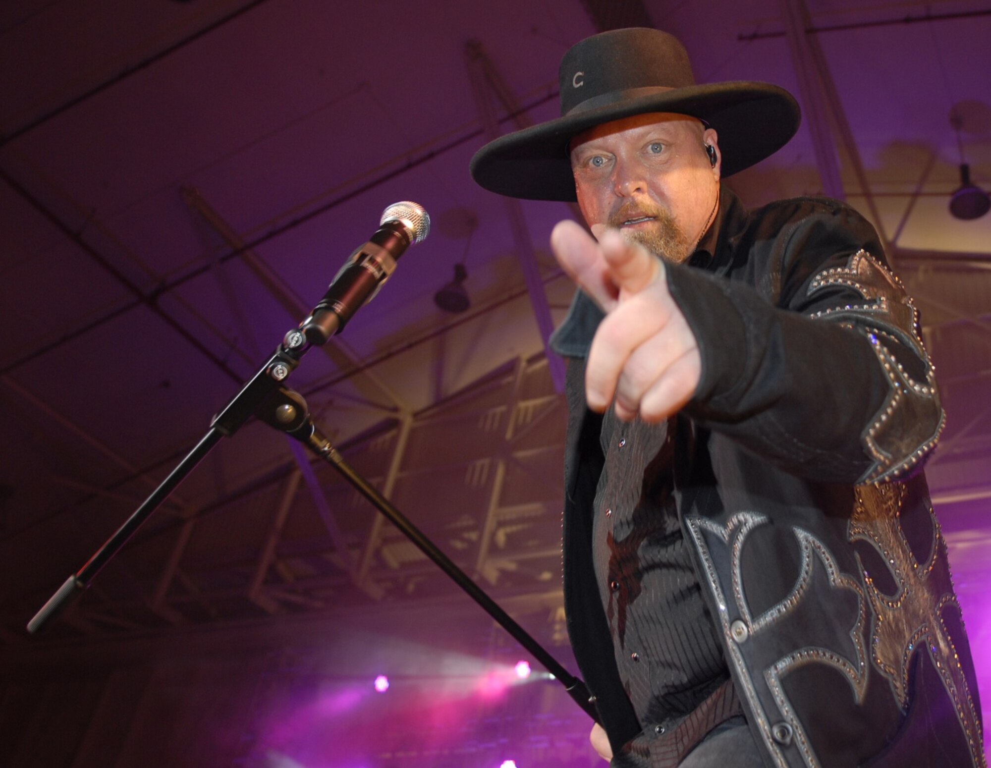 Eddie Montgomery, of country duo Montgomery Gentry, gets up close and personal with the crowd during a USO concert on Kadena Air Base, Japan, Jan. 28. The duo’s visit to Okinawa was the last of a four-stop USO tour. (U.S. Air Force photo/ Airman 1st Class Tara A. Williamson)
