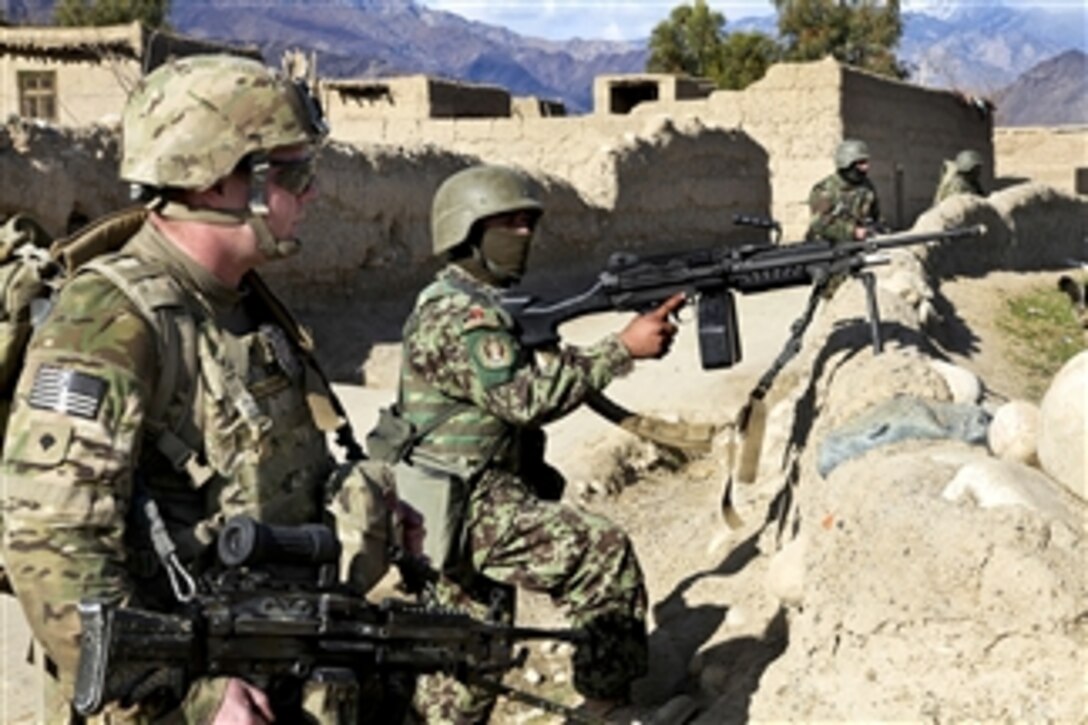 U.S. Army Spc. Mason Lembke and Afghan soldiers provide security during a patrol through Mangow village in Afghanistan's Laghman province on Jan. 21, 2011.  Lembke, assigned to Headquarters Company, 1st Battalion, 133rd Infantry Regiment, provided security while members of the 319th Tactical Psychological Operations Company talked to villagers about security.  