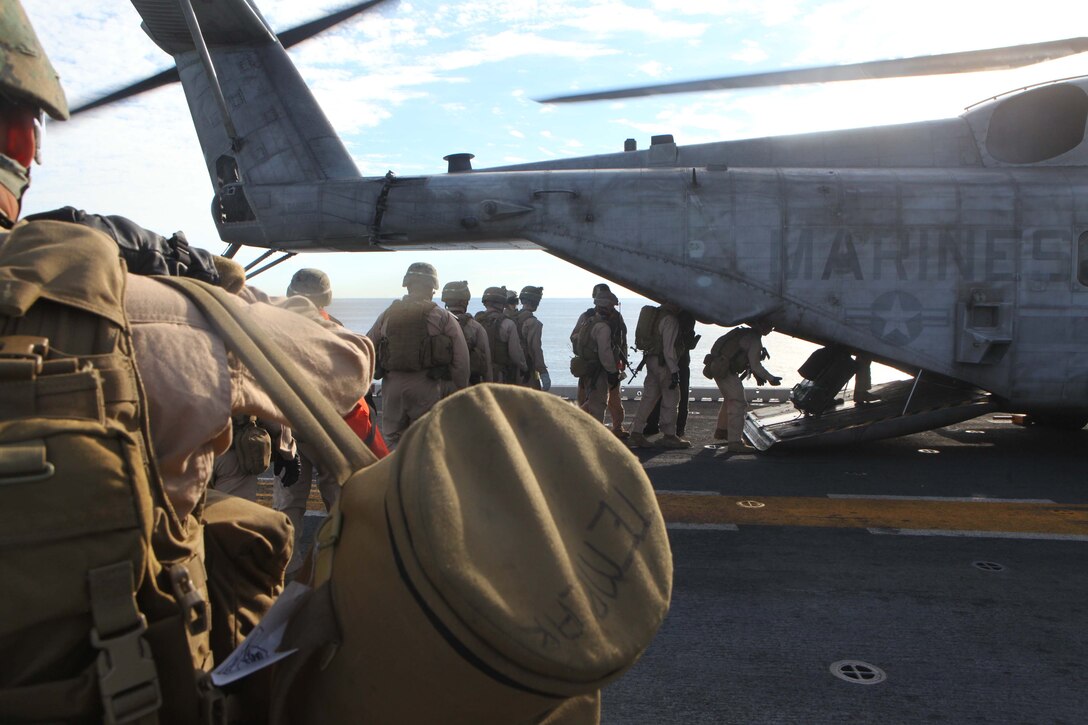 Marines and Sailors with the 24th Marine Expeditionary Unit’s Force Reconnaissance Platoon and Security Element, Headquarters and Service Company, Battalion Landing Team 1st Battalion, 2nd Marine Regiment, load a CH-53E Super Stallion helicopter prior to conducting a simulated Visit, Board, Search and Seizure aboard the USNS Laramie, Jan. 31, 2012.  The 24th MEU is conducting their Certification Exercise (CERTEX) with Iwo Jima Amphibious Ready Group scheduled Jan. 27 to Feb. 17, which includes a series of missions intended to evaluate and certify the unit for their upcoming deployment.  The CH-53E helicopters are a detachment from Marine Heavy Helicopter Squadron 464 based at Marine Corps Air Station New River, N.C., and comprise part of Marine Medium Tiltrotor Squadron VMM-261 (Rein), which is the Aviation Combat Element for the 24th MEU.