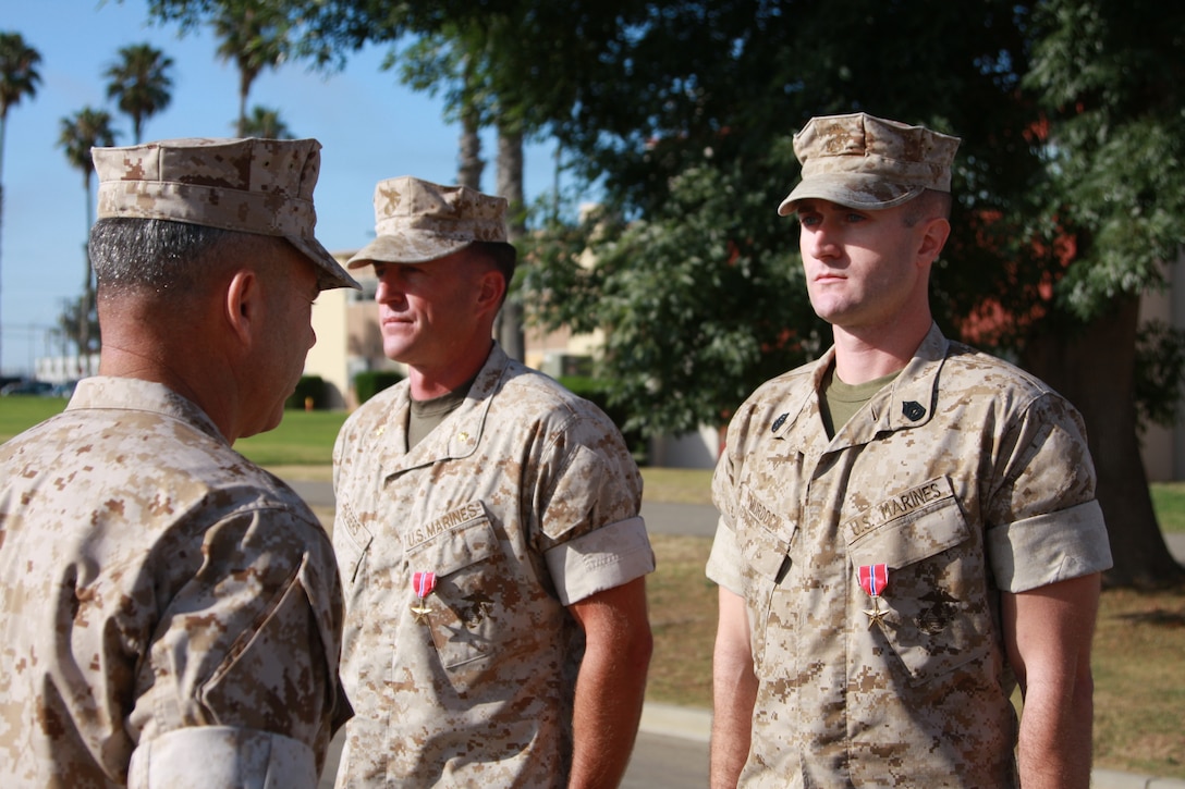 Maj. Christopher W. Rogers, team leader, 3d Civil Affairs Group, I Marine Expeditionary Force, and Gunnery Sgt. Christian W. Murdock, team chief, 3d CAG, are presented with the Bronze Star by Col. Paul Lebidine, commanding officer for 3d CAG, July 1. The Marines received the awards for multiple operations which resulted in a reduced ability to fund insurgent operations through a decline of enemy activity and increased security in support of Operation Enduring Freedom.