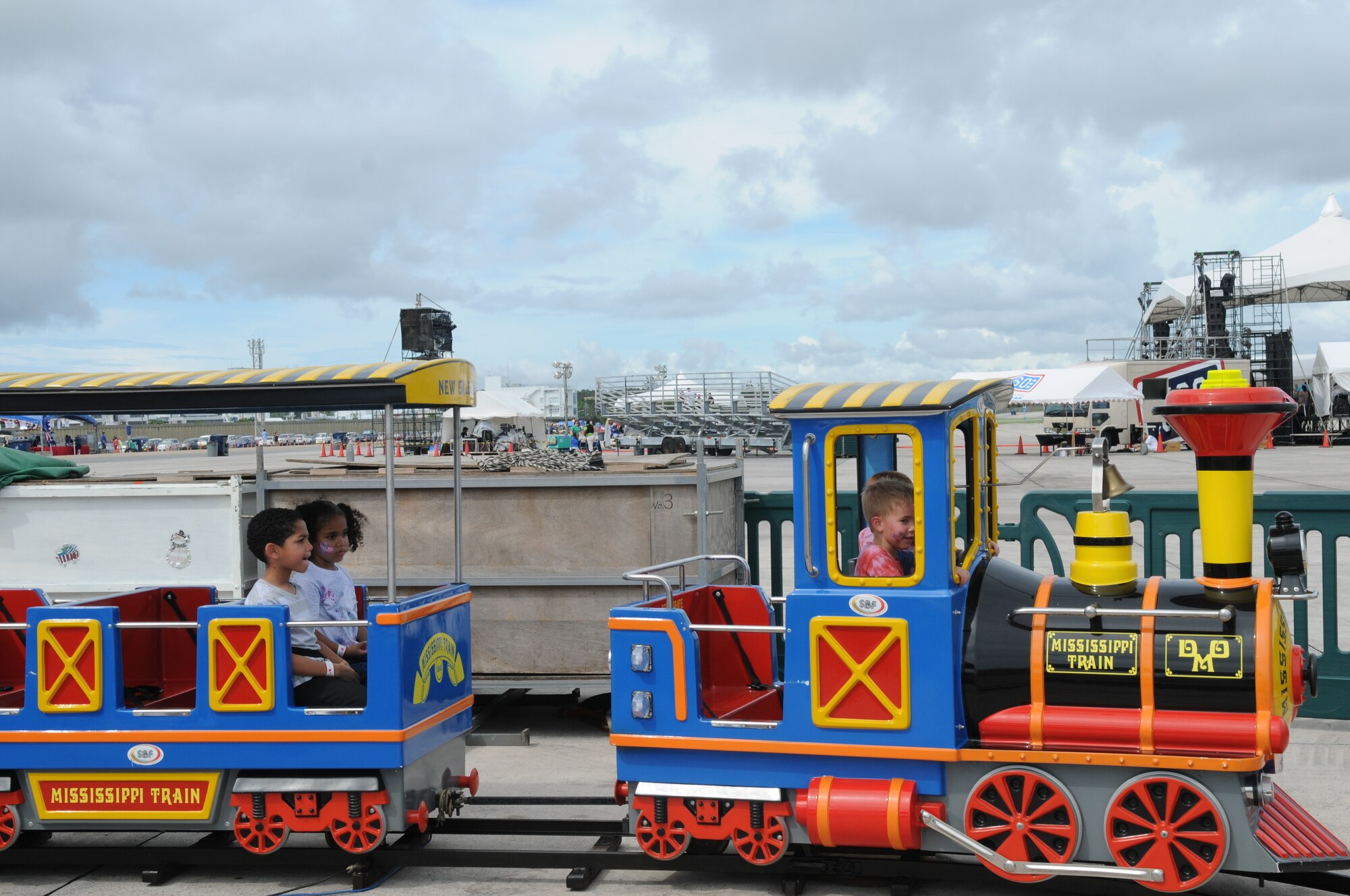Young AmericaFest participants ride a children's train in the Kiddieland July 1 during AmericaFest at Kadena Air Base, Japan. AmericaFest took place on the Kadena flight line July 1 and 2. (U.S. Air Force photo/Staff Sgt. Amanda Savannah)
