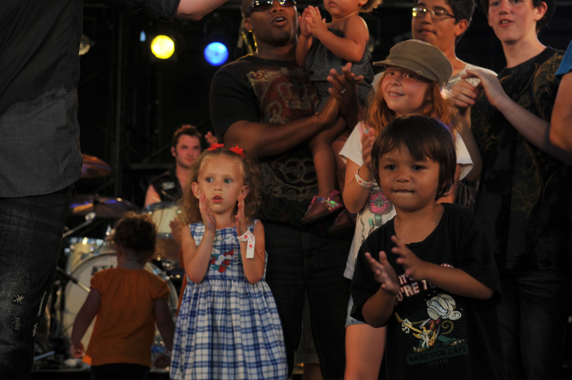 Families join the band "12 Stones" onstage as they perform during AmericaFest 2011, July 1. AmericaFest takes place July 1 and 2, and is an event designed to build international relations with the local Okinawan community. (U.S. Air Force photo/Tech. Sgt. Angelique Perez)