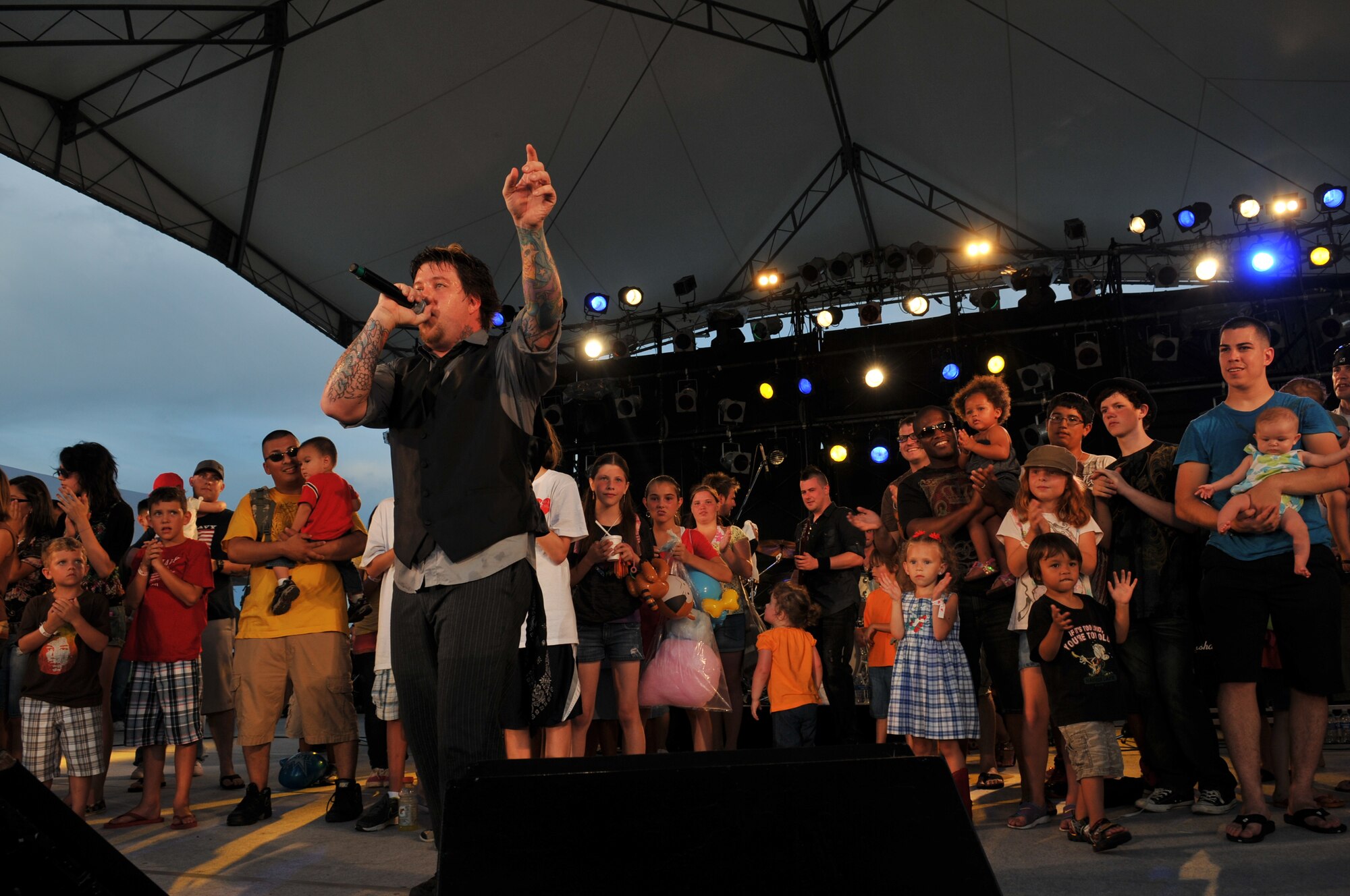Families join the band "12 Stones" onstage as they perform during AmericaFest 2011, July 1. AmericaFest takes place July 1 and 2, and is an event designed to build international relations with the local Okinawan community. (U.S. Air Force photo/Tech. Sgt. Angelique Perez)