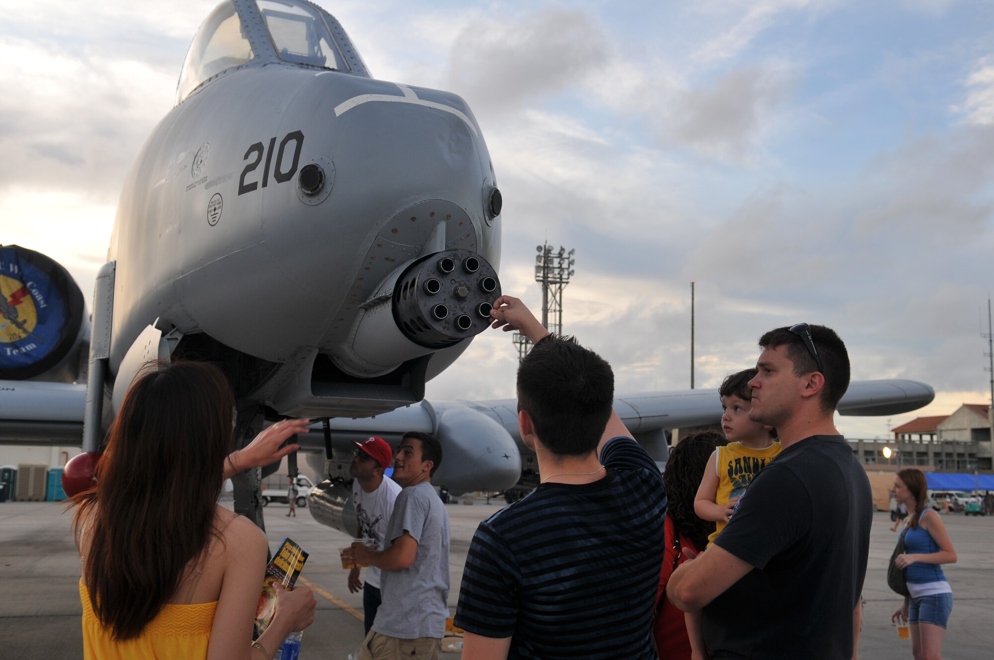 Families check out the various U.S. Air Force, Marine Corps, and Japanese aircraft on display during AmericaFest 2011, July 1. AmericaFest takes place July 1 and 2, and is an event designed to build international relations with the local Okinawan community. (U.S. Air Force photo/Tech. Sgt. Angelique Perez)