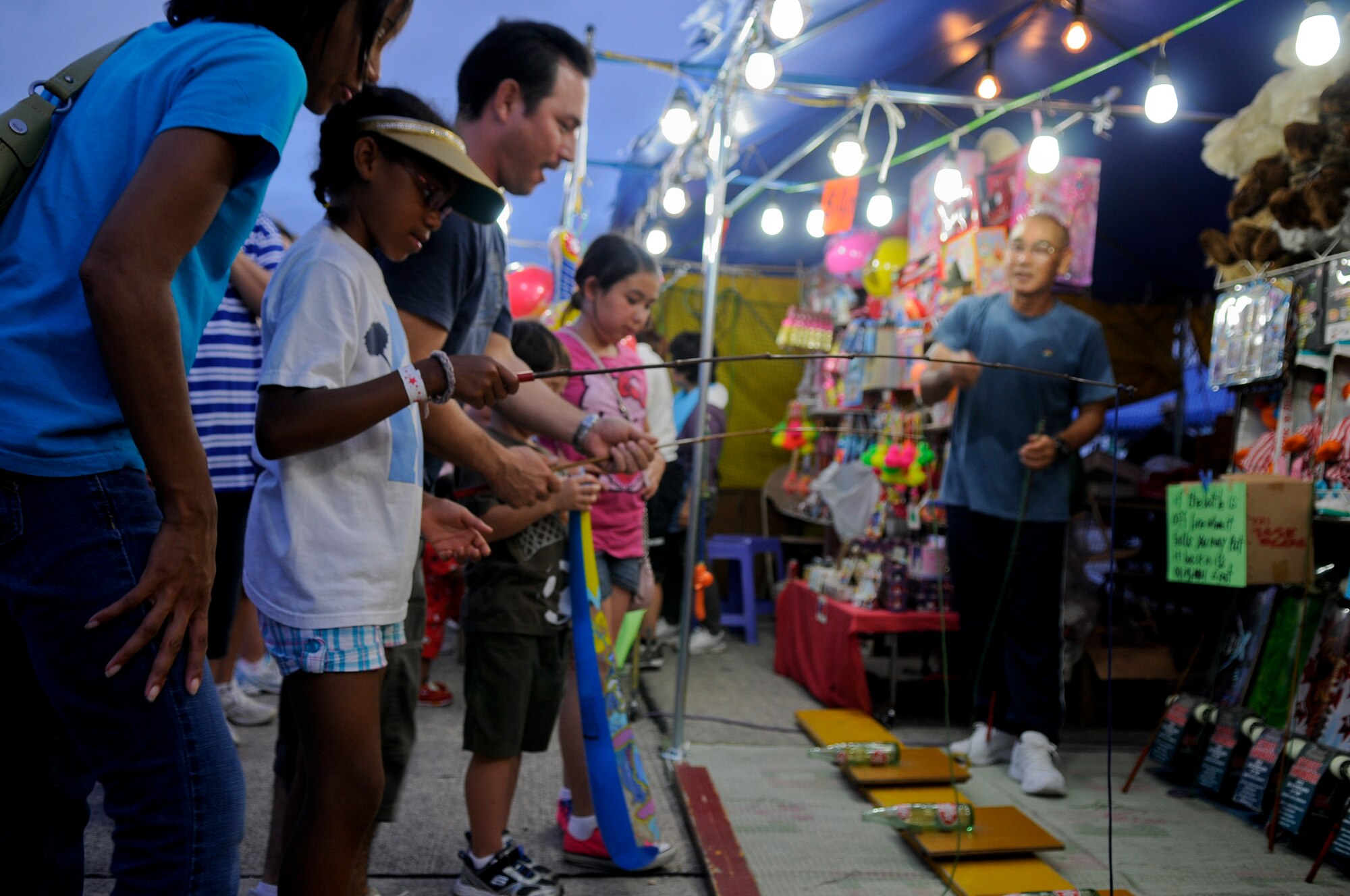 Master Sgt. Francesca Seehausen from the 18th Dental Squadron and her daughter, Dommonique Wheeler play one of the games at AmericaFest on Kadena Air Base, Japan, July 1. The event featured an array of food, games and live entertainment for Americans and Okinawans in celebration of Independence Day. (U.S. Air Force photo/ Airman 1st Class Maeson L. Elleman)