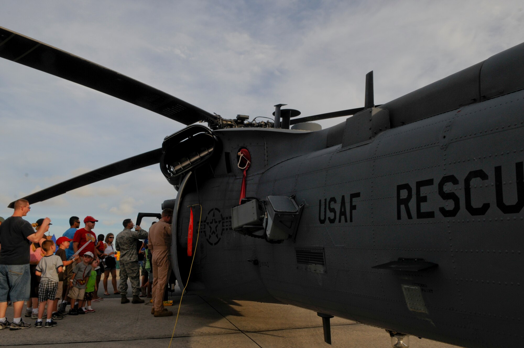 A U.S. Air Force HH-60 Pave Hawk helicopter pilot shows off his aircraft at AmericaFest on Kadena Air Base, Japan, July 1. Fourteen American aircraft from military bases across the island and country, as well as four Japan AirSelf-Defense Force aircraft  came together on Kadena to showcase the capabilities of the partnered forces inJapan. (U.S. Air Force photo/ Airman 1st Class Maeson L. Elleman)