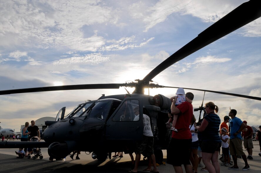 A group of onlookers view a U.S. Air Force HH-60 Pave Hawk helicopter at AmericaFest on Kadena Air Base, Japan, July 1. Fourteen American aircraft from military bases across the island and country, as well as four Japan Air Self-Defense Force aircraft came together on Kadena to showcase the capabilities of the partnered forces in Japan. (U.S. Air Force photo/ Airman 1st Class Maeson L. Elleman)
