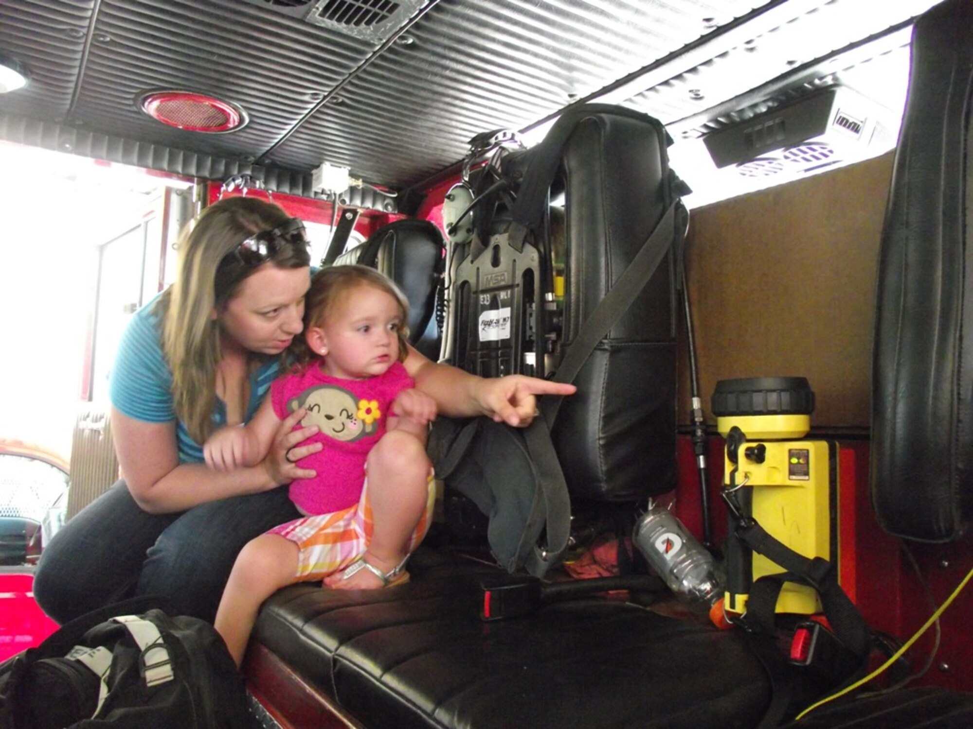 Anjanet Doehling and her daughter Eliana explore the inside of a fire truck at Fire Station Number 1 during a Hearts Apart event June 24.  Courtesy Photo by Danny Monahan