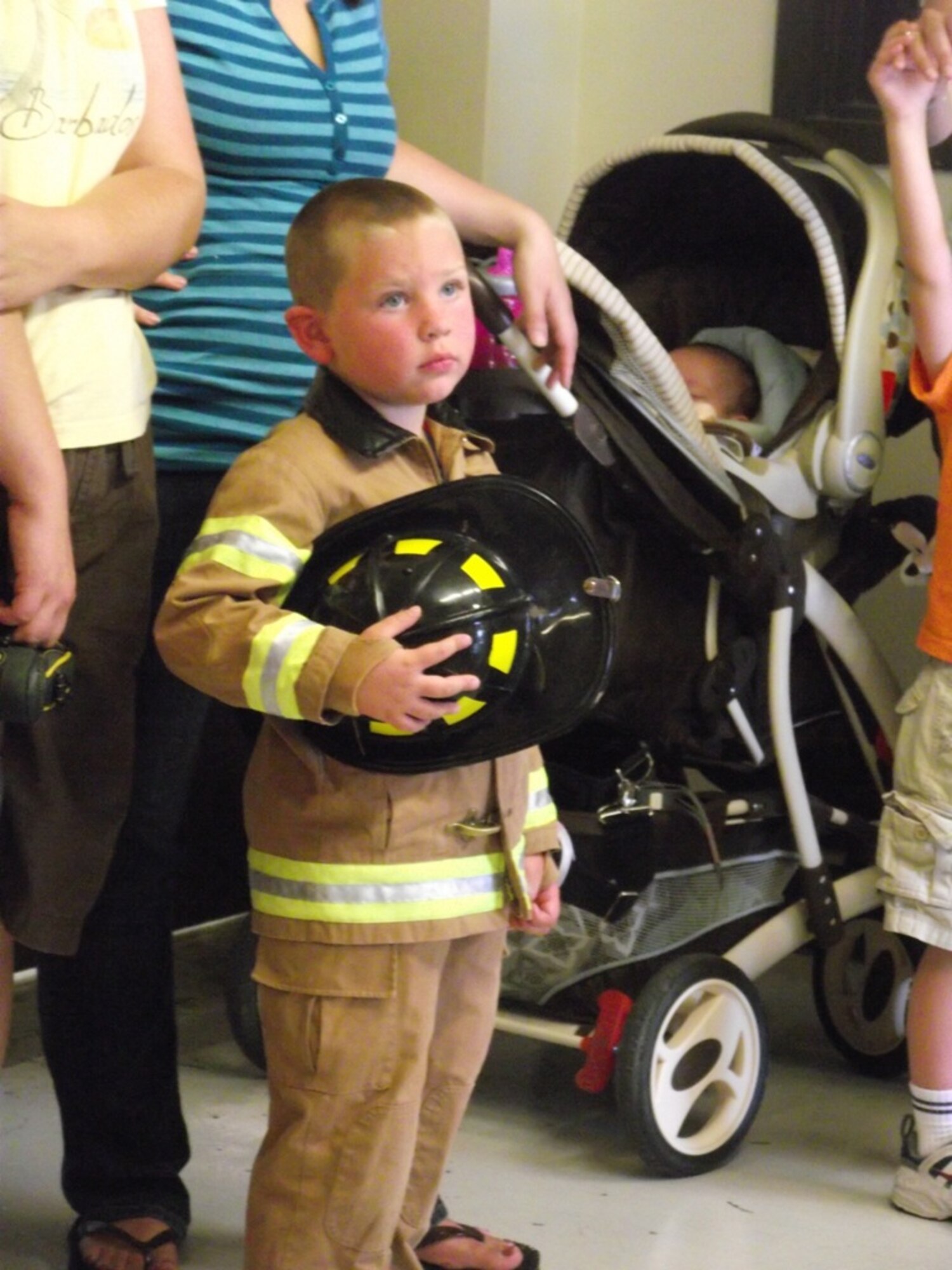 Hinckley Carter, son of Bethany and Capt. Troy Carter, waits to board a fire truck at Fire Station Number 1 during a Hearts Apart event.  Courtesy Photo by Danny Monahan