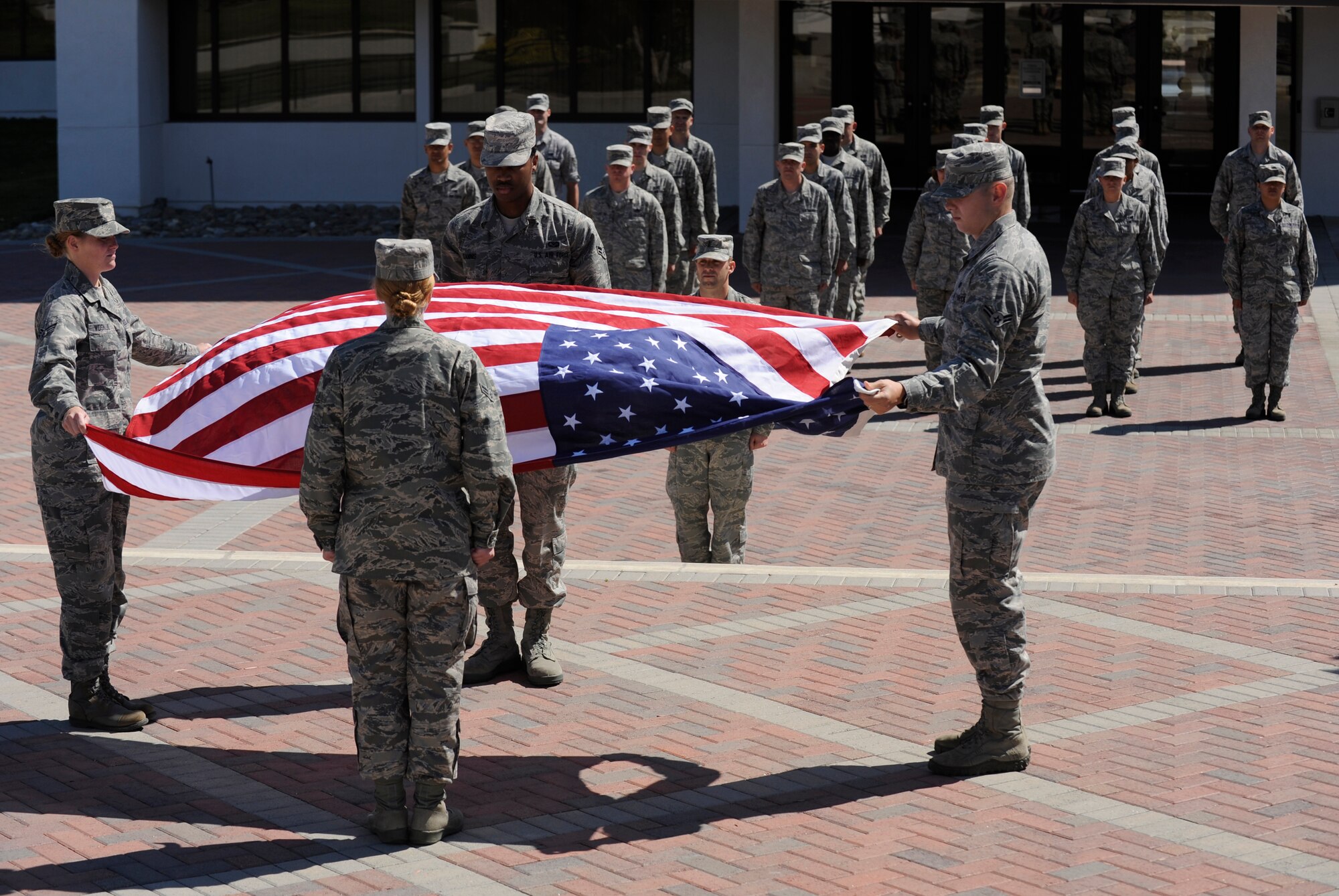 VANDENBERG AIR FORCE BASE, Calif. -- Members of the Wing Staff Agencies stand in formation during a retreat ceremony at the headquarters building here Thursday, June 30, 2011.  Senior Airman Danielle Voskuil and Airman 1st Class Jamie Johnston, of the 30th Comptroller Squadron, and Airmen 1st Class Maegann Bartolome and Darian Tannis, of the 30th Space Wing Wing Staff Agency, participated in the color guard during the ceremony.   (U.S. Air Force photo/Staff Sgt. Andrew Satran) 

  