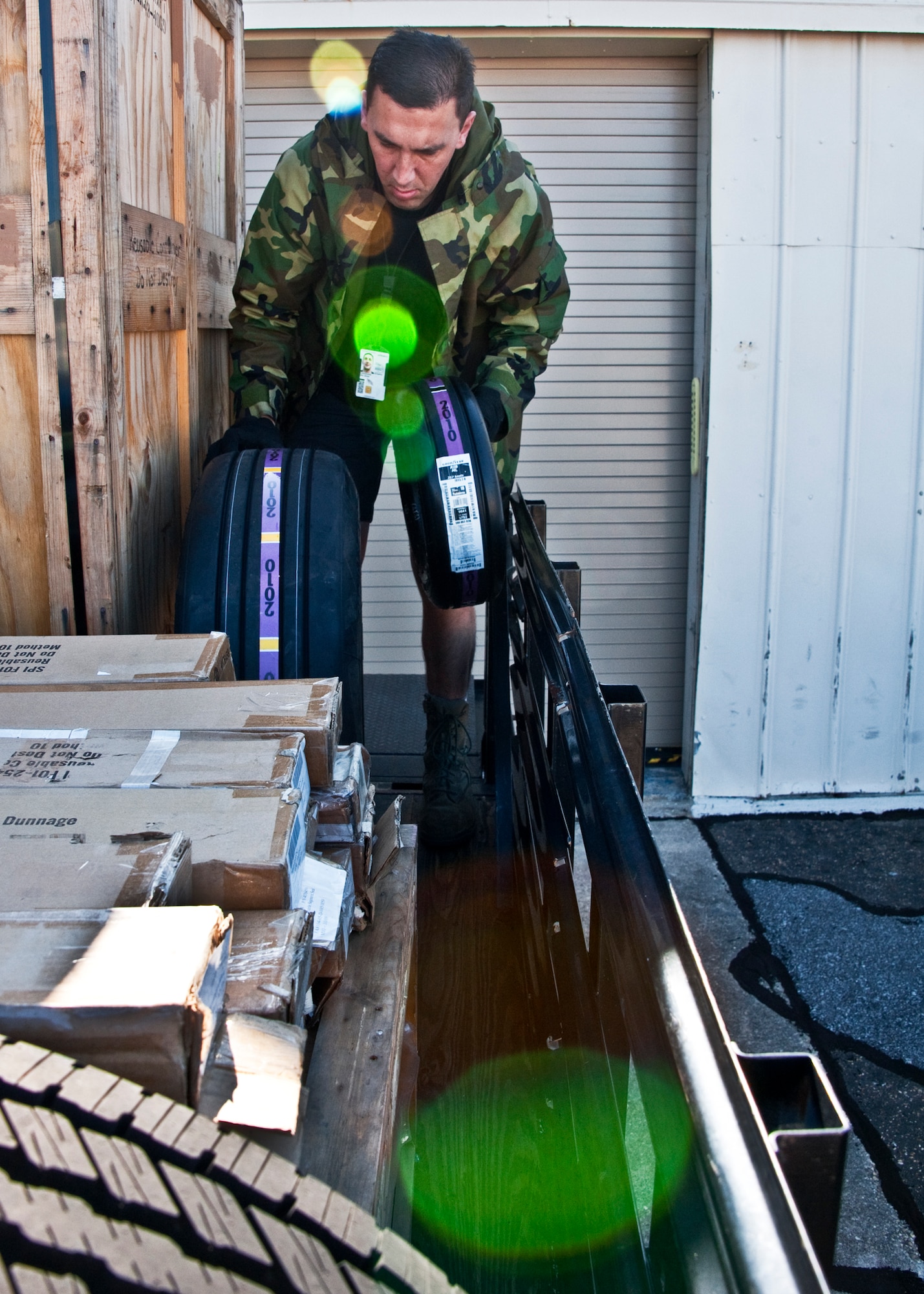 Eric Bonebrake, 96th Logistics Readiness Squadron, grabs tires to be delivered to the 46th Test Wing at Eglin.  Mr. Bonebrake works as a pick-up and delivery driver within the vehicle operations section under 96th LRS.  He and other delivery drivers shuttle supplies to and from various maintenance locations twice daily.  Vehicle operations is part of the larger Distribution flight under 96 LRS.  (U.S. Air Force photo/Samuel King Jr.)    