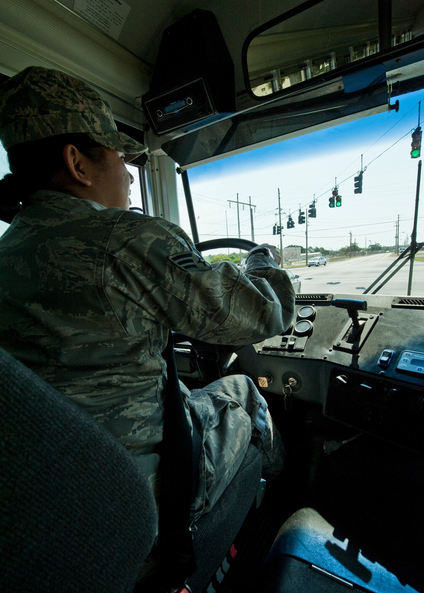 Senior Airman Michelle Wamsley, 96th Logistics Readiness Squadron vehicle operations, makes a wide turn at the green light during a pick-up and delivery mission on Eglin.   Vehicle operations Airmen are responsible for all passenger movement using military buses on base.  Larger vehicles like buses also receive the same thorough inspection “check-out” vehicles go through.  The Airmen of vehicle operations are responsible for driving, upkeep, dispatching and delivery of more than 130 vehicles on base.   The vehicle operations flight managed more than 13 thousand transportation requests last year.  (U.S. Air Force photo/Samuel King Jr.) 