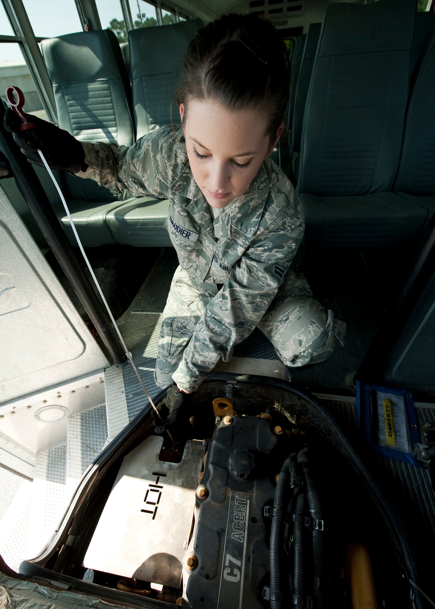 Airman 1st Class Jessica Baudier, 96th Logistics Readiness Squadron vehicle operations, checks the fluids as part of her routine before taking the bus out to pick up passengers on Eglin.  Vehicle operations Airmen are responsible for all passenger movement using military buses on base.  Larger vehicles like buses also receive the same thorough inspection “check-out” vehicles go through.  The Airmen of vehicle operations are responsible for driving, upkeep, dispatching and delivery of more than 130 vehicles on base.   The vehicle operations flight managed more than 13 thousand transportation requests last year.  (U.S. Air Force photo/Samuel King Jr.) 