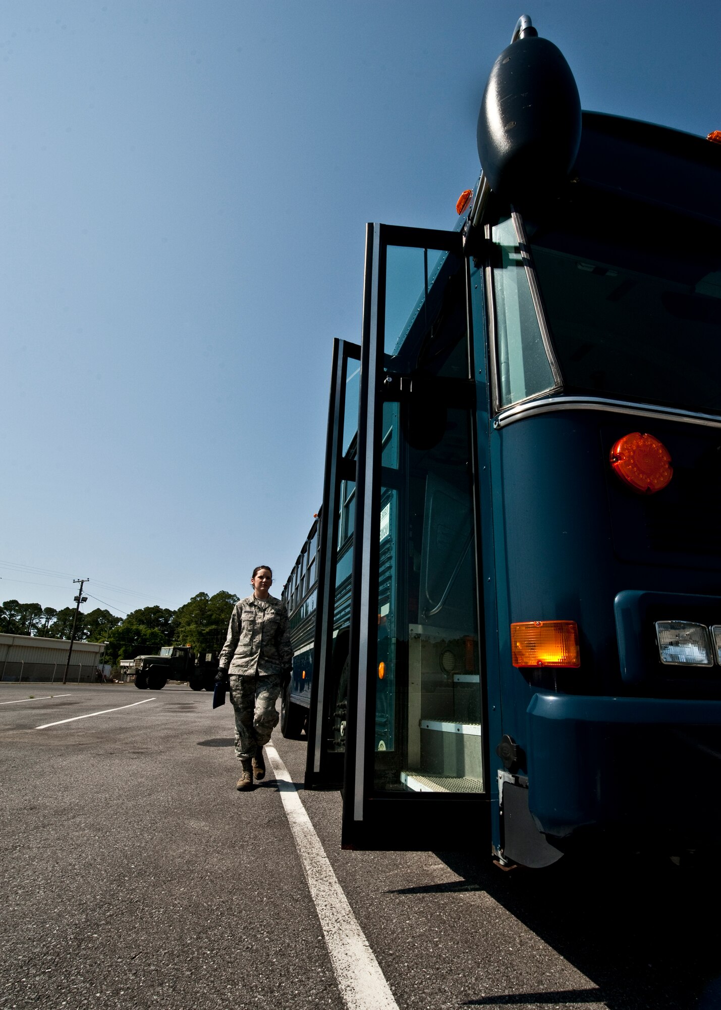 Airman 1st Class Jessica Baudier, 96th Logistics Readiness Squadron vehicle operations, walks out to the bus before picking up passengers on Eglin.  Vehicle operations Airmen are responsible for all passenger movement using military buses on base.  Larger vehicles like buses also receive the same thorough inspection “check-out” vehicles go through.  The Airmen of vehicle operations are responsible for driving, upkeep, dispatching and delivery of more than 130 vehicles on base.   The vehicle operations flight managed more than 13 thousand transportation requests last year.  (U.S. Air Force photo/Samuel King Jr.) 