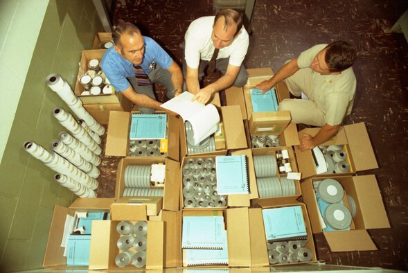 NASA representative John Warmbrod, left; ARO project engineer R.K. Matthews, center, and Air Force representative to VKF, Maj. R.W. Working, examine the vast amount of data produced in the heat transfer phase of the test programs. Similar amounts were produced in the other phases. (AEDC file photo)