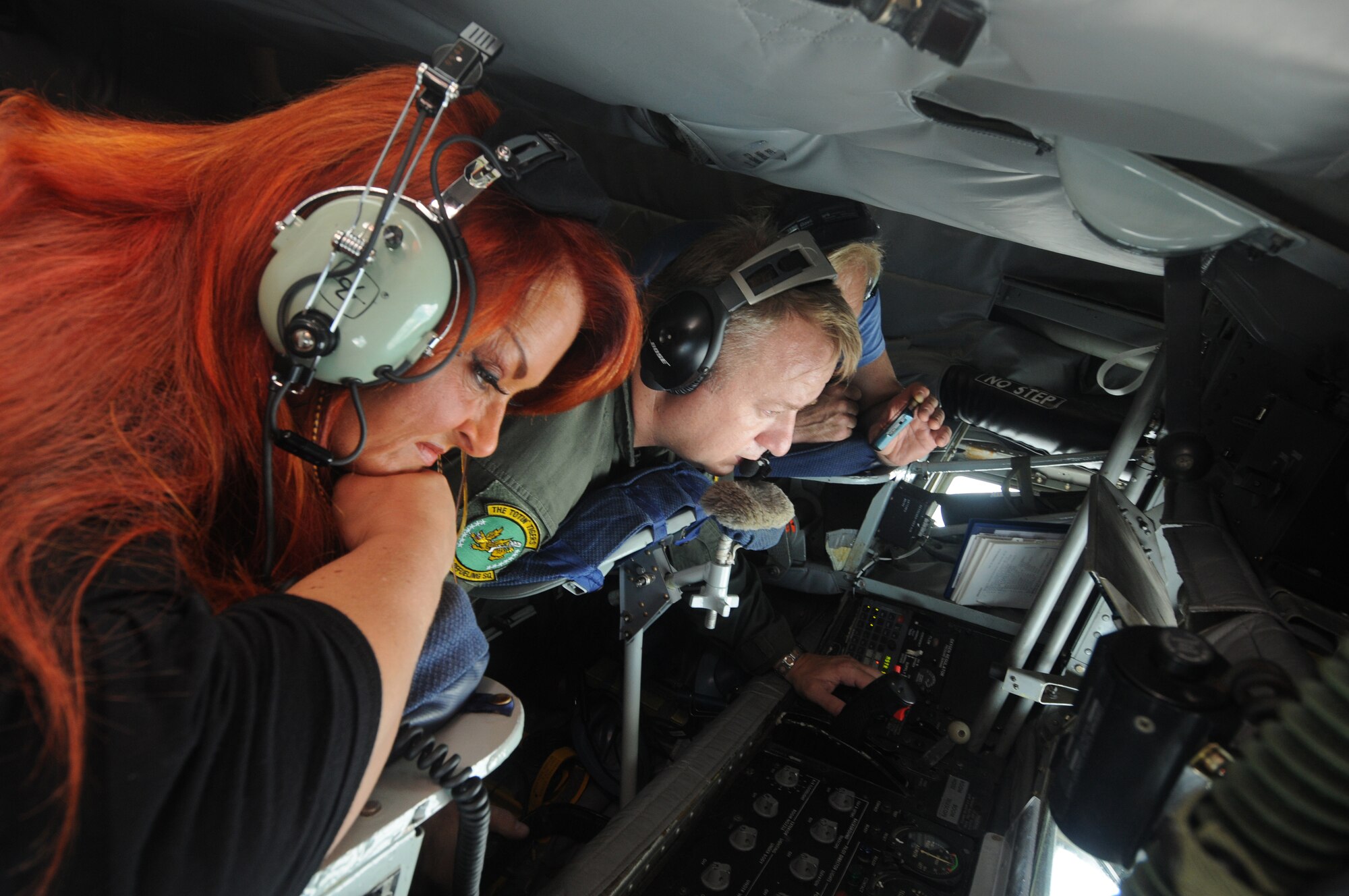 Wynonna Judd observes as Master Sgt. Riccardo Bonicelli operates the boom in a KC-135 during an in-flight refueling mission June 30, 2011, somewhere over the southeastern United States. Ms. Judd, a 5-time Grammy Award winning country singer, is the featured artist for the Independence Day Concert in Warner Robins, Ga., July 1. The KC-135 from the Air Force Reserve's 916th Air Refueling Wing, refueled a pair of F-15E Strike Eagles during the mission. (U.S. Air Force photo/Ken Hackman)