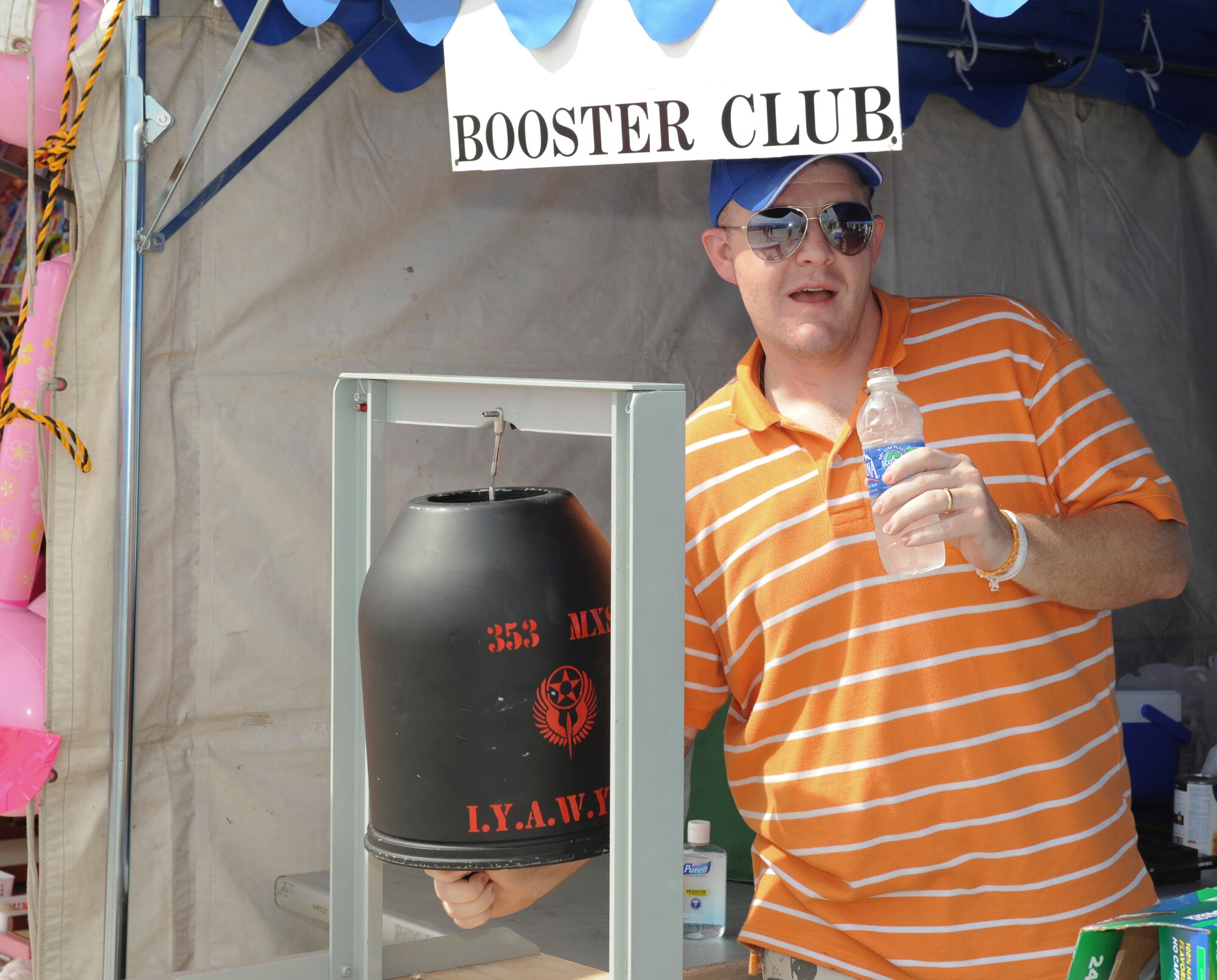 Staff Sgt. Thomas McAfee, 353 Special Operations Maintenance Squadron, rings a bell loudly to attract customers to his squadron’s booth at Kadena’s AmericaFest, Kadena Air Base, Japan, July 1. The 353rd was selling a variety of barbequed products that were promised to put you in a “meat coma”. (U.S. Air Force photo/Airman 1st Class Brooke P. Beers)
