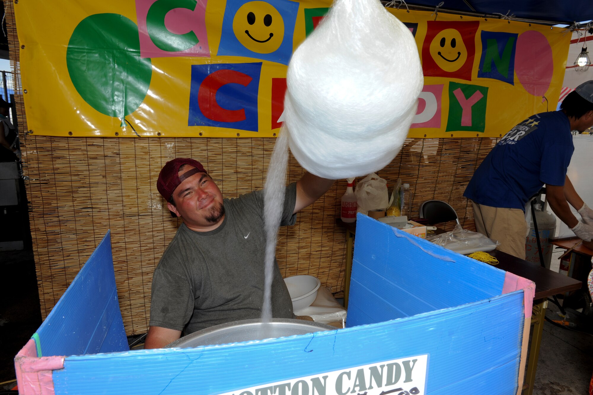 A vendor makes giant bundles of cotton candy to sell during Kadena’s AmericaFest, Kadena Air Base, Japan, July 1. AmericaFest was a celebration of our Independence Day but It was not celebrated alone. Japanese citizens were also invited to partake in the fun the event provided. (U.S. Air Force photo/Airman 1st Class Brooke P. Beers)