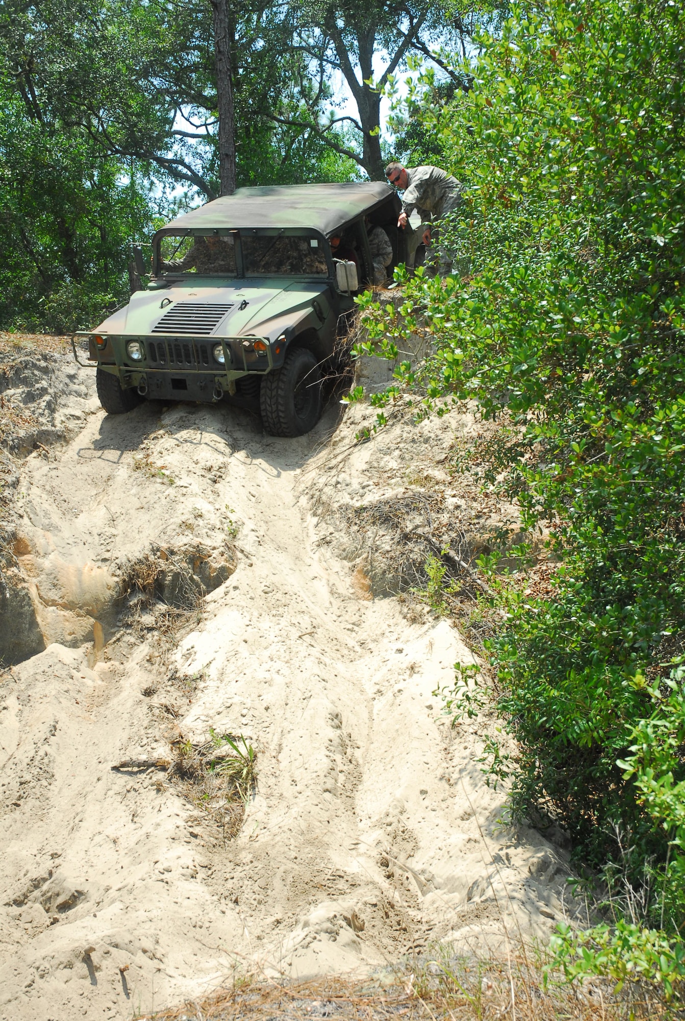 Dr. Fred P. Lewis, Director of Weather for the U.S. Air Force, drives a HUMVEE through a familiarization course at Camp Blanding Joint Training Center, June 21, 2011. Lewis was at Camp Blanding to discuss the future of the weather career field and to see firsthand the training offered to Air Force weathermen who deploy with Army units. Photo by Sgt. 1st Class Blair Heusdens