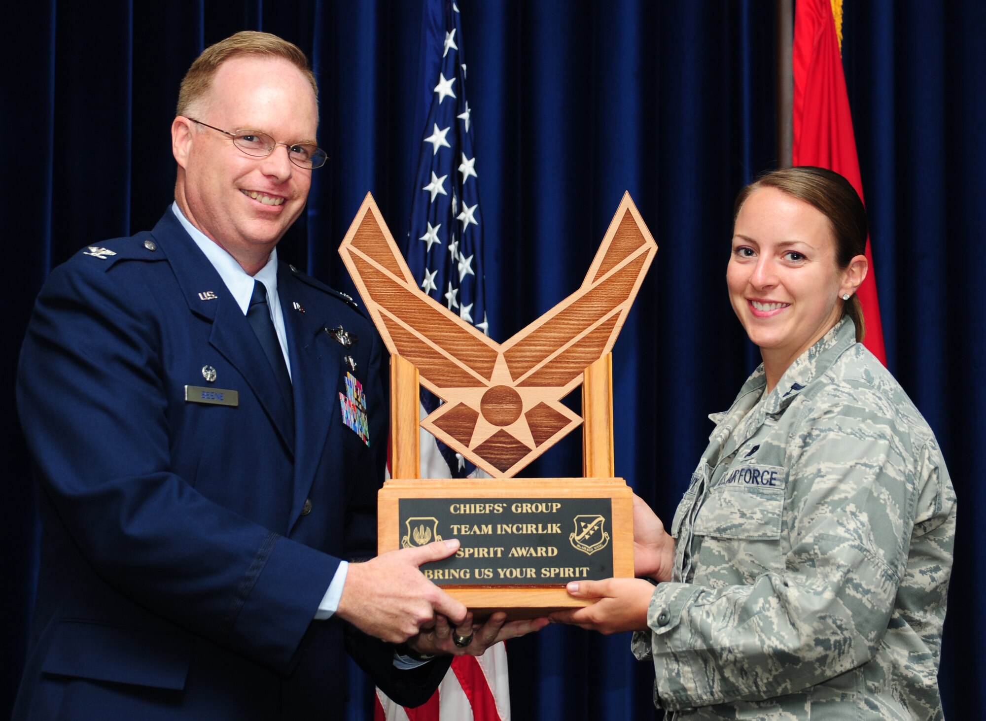 Col. Eric Beene, 39th Air Base Wing commander, awards the Chiefs’ Group Team Incirlik Spirit Award to the 39th Logistics Readiness Squadron during the monthly promotion ceremony June 30, 2011, at the Club Complex Ballroom at Incirlik Air Base, Turkey. (U.S. Air Force photo by Senior Airman Anthony Sanchelli/Released)