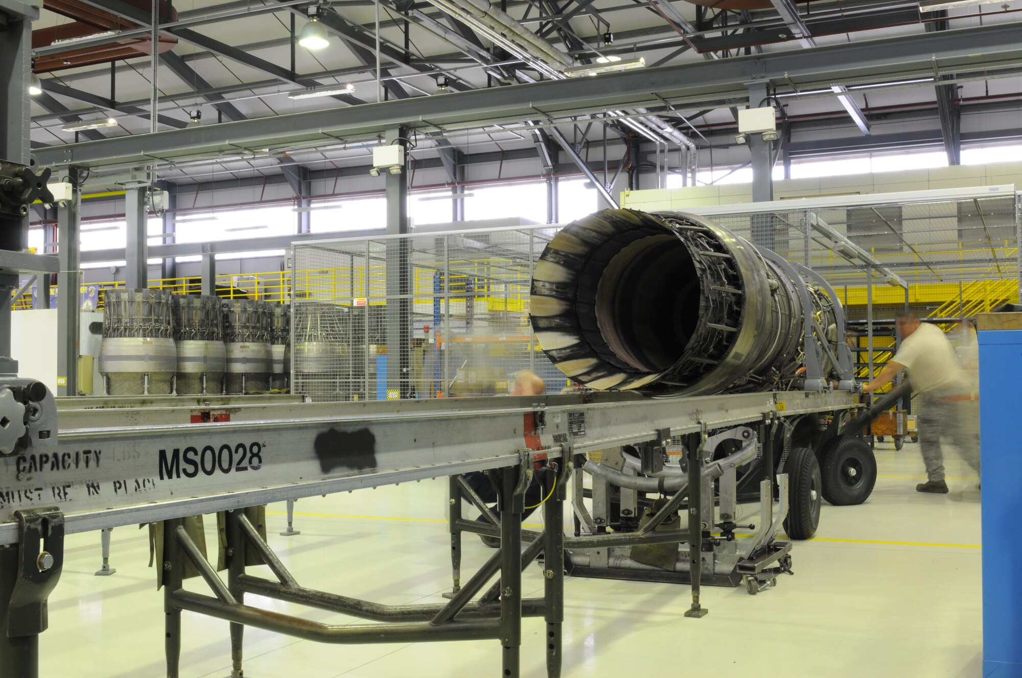 ROYAL AIR FORCE LAKENHEATH, England - 48th Component Maintenance Squadron Airmen place an F100-PW-220 engine aircraft onto a rack in building 1225 on June 28, 2011. The 48th CMS Propulsion Flight was recently awarded the Pratt and Whitney Golden Wrench award for their efficient engine repair processes. (U.S. Air Force photo/Airman Cory Payne)