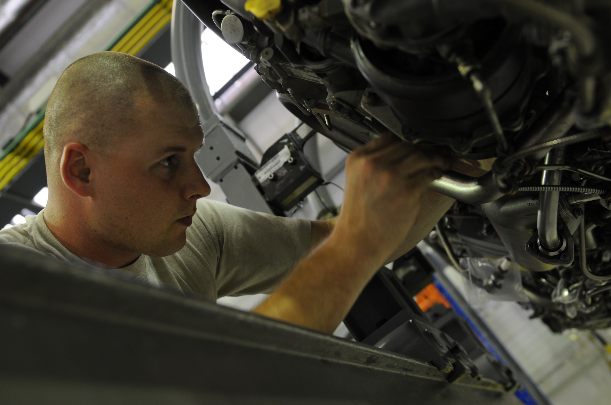 ROYAL AIR FORCE LAKENHEATH, England - Staff Sgt. Charlie Roberson, 48th Component Maintenance Squadron aerospace propulsion journeyman, installs a pressure dump valve on an F100-PW-220 aircraft engine in building 1225 on June 28, 2011. The 48th CMS Propulsion Flight was recently awarded the Pratt and Whitney Golden Wrench award for their efficient engine repair processes. (U.S. Air Force photo/Airman Cory Payne)