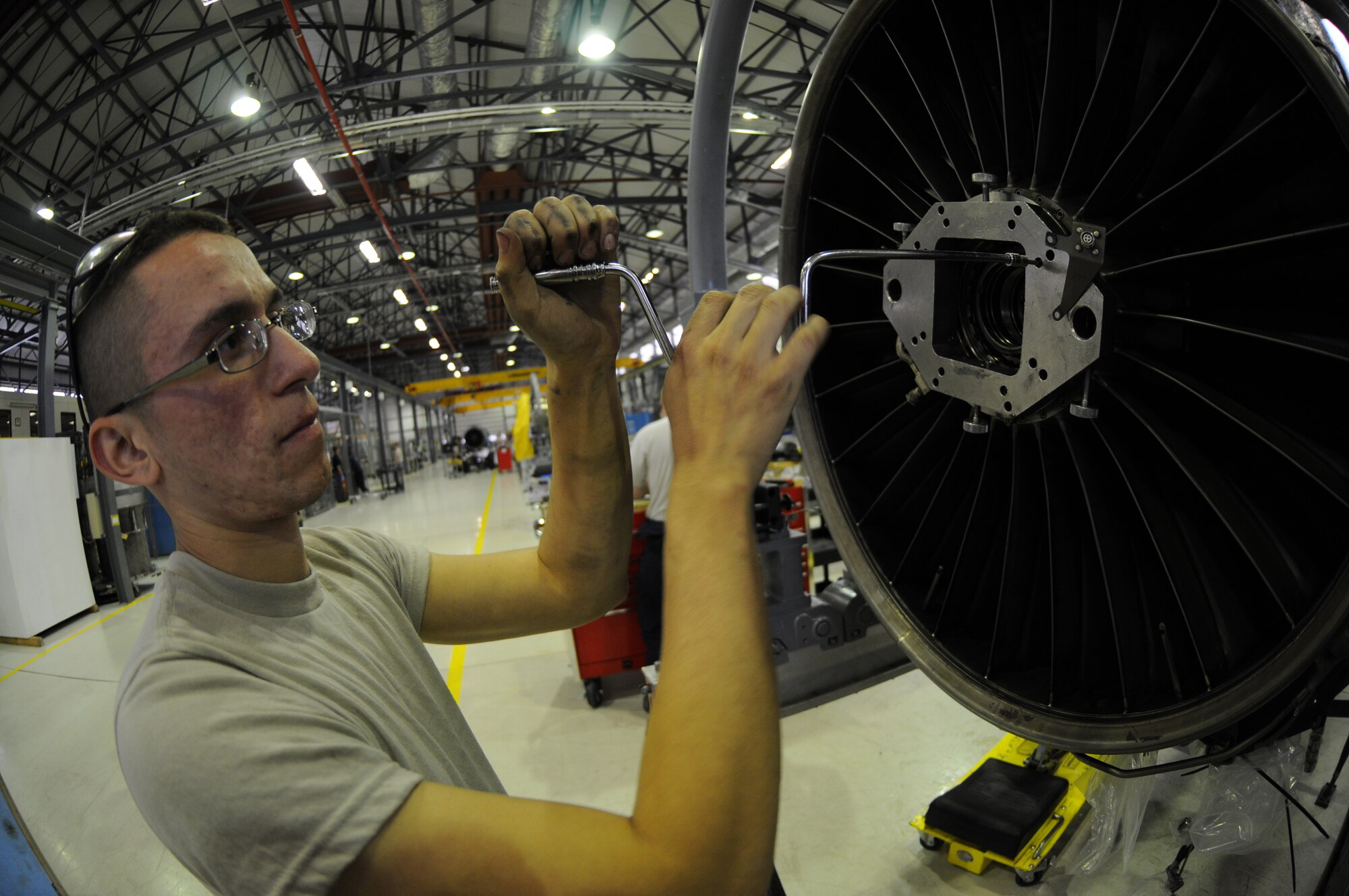 ROYAL AIR FORCE LAKENHEATH, England - Airman 1st Class Ignacio Sandoval, 48th Component Maintenance Squadron aerospace propulsion journeyman, removes bolts from an F100-PW-220 aircraft engine in building 1225 on June 28, 2011. The 48th CMS Propulsion Flight was recently awarded the Pratt and Whitney Golden Wrench award for their efficient engine repair processes. (U.S. Air Force photo/Airman Cory Payne)