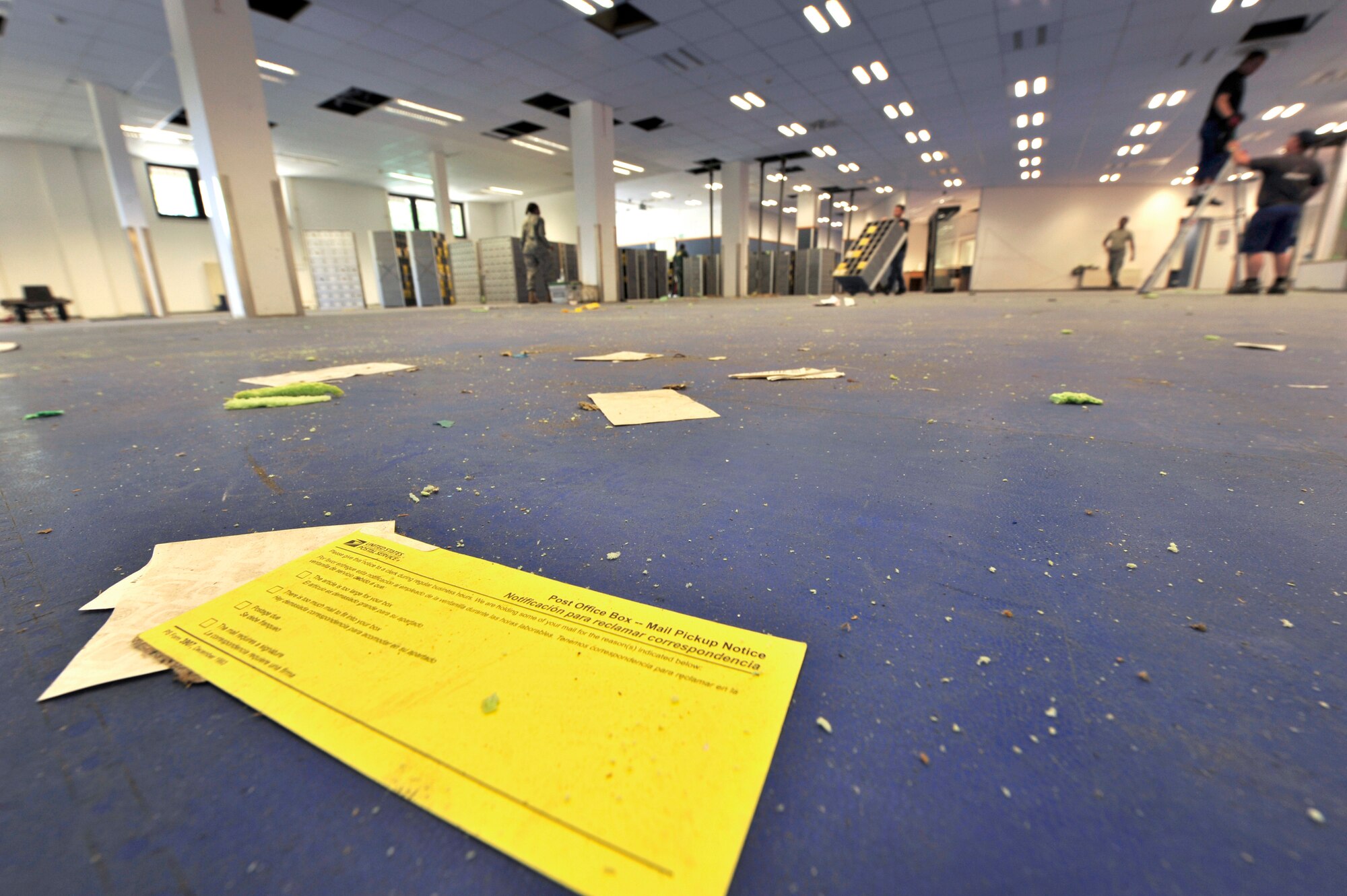 RAMSTEIN AIR BASE, Germany -- Blank parcel pick-up notice forms at Northside
Postal Annex lie in the midst of workers removing mailboxes and light
fixtures for relocation to the old Base Exchange here, June 30, 2011.  The
post office moved its operating location due to safety concerns with the
roof of the building.  Within 24 hours, post office personnel along with
more than 100 volunteers relocated 10,000 mailboxes and 2,000 packages to
their new location.  The post office personnel maintained full operations at
both locations during the move to minimize any customer inconvenience. The
Northside Post Annex averages 3,000 to 5,000 customer parcel pick-ups per
week and 13 million pounds of mail and packages per year. The cost for the
move, repairs and the move back totals to approximately $4.5 million.
Authorized parking for the temporary post office is located at the Northside
Chapel parking lot. (U.S. Air Force Photo by Tech. Sgt. Chenzira Mallory)

