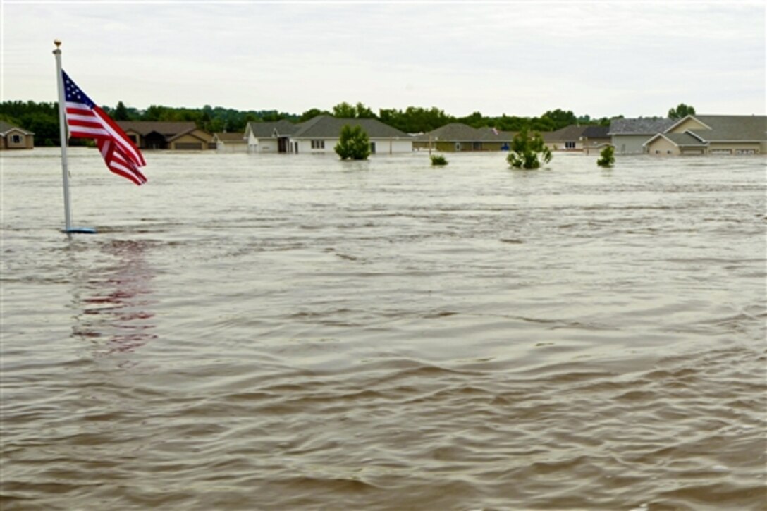 A U.S. flag waves above nearly 10 feet of water in Minot, N.D., June 26, 2011. The Souris River has inundated the city, reaching a historic height and flooding thousands of 4,000 homes. 