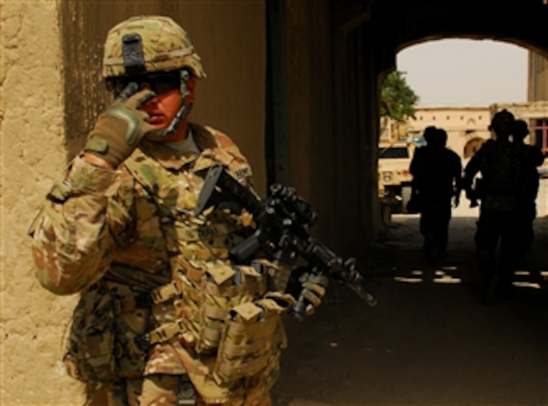 U.S. Army Staff Sgt. Edward Duran, with Operations Company, Headquarters and Headquarters Battalion, Task Force Maverick, 1st Cavalry Division, directs his security force while providing security for Army officials as they visit Bala Hissar, a fortress serving as a base for a new Afghan quick reaction force in Gardez, Afghanistan, on June 27, 2011.  The visit was part of an effort to determine what facilities and training the Afghan security force need.  