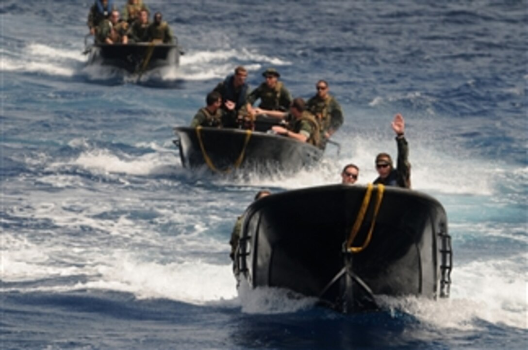 A Dutch Marine (right), with the Royal Netherlands Marine Corps, directs U.S. sailors with Riverine Squadron 3 during a come along side maneuver with the Dutch logistic support vessel HNLMS Pelikaan (A804) in the Caribbean Sea on June 28, 2011.  Sailors from Riverine Squadron 3 were cross-training with elements of the Royal Netherlands Marine Corps and Navy for a three-week training course designed to familiarize U.S. Navy riverine squadrons with Dutch ship-to-shore amphibious operations.  