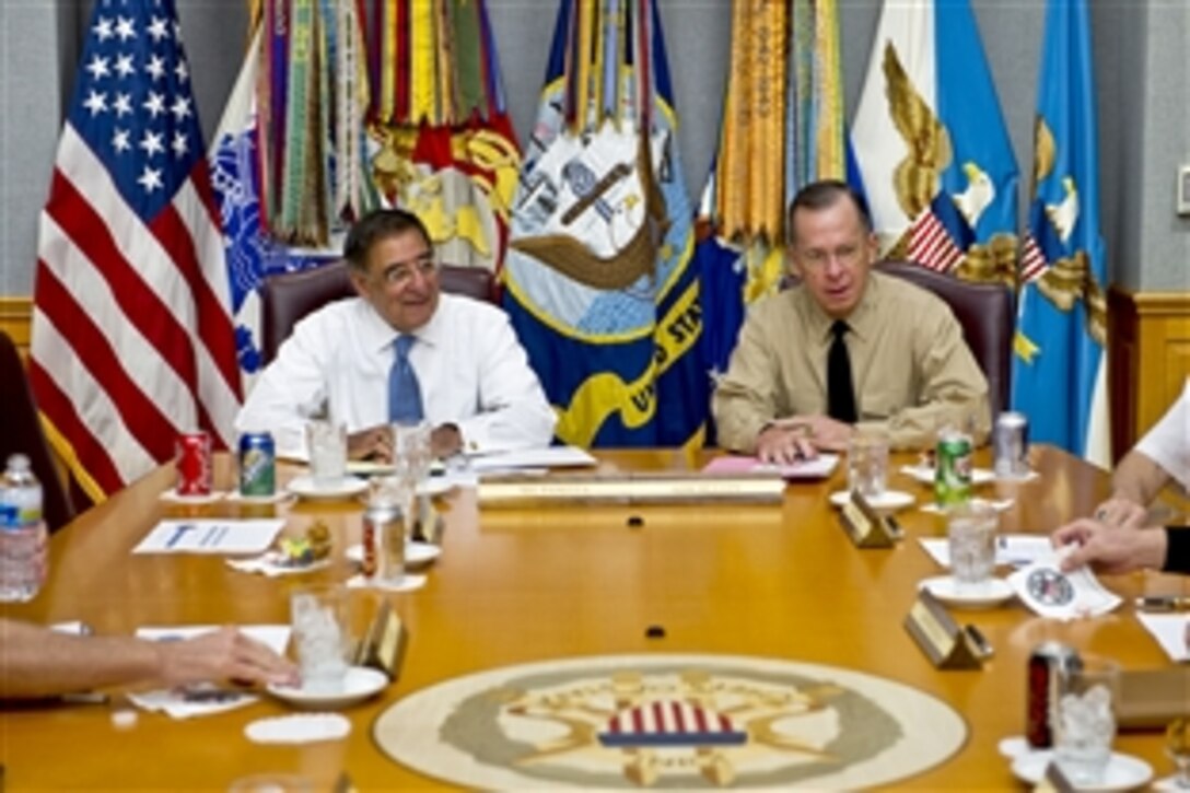 New Defense Secretary Leon E. Panetta, left, speaks with Navy Adm. Mike Mullen, chairman of the Joint Chiefs of Staff, during Panetta's first visit to "The Tank" to meet with the Joint Chiefs at the Pentagon, July 1, 2011.