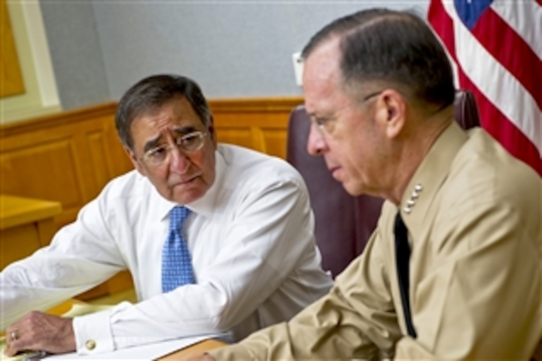 New Defense Secretary Leon E. Panetta, left, speaks with Navy Adm. Mike Mullen, chairman of the Joint Chiefs of Staff, during Panetta's first visit to "The Tank" to meet with the Joint Chiefs at the Pentagon, July 1, 2011.