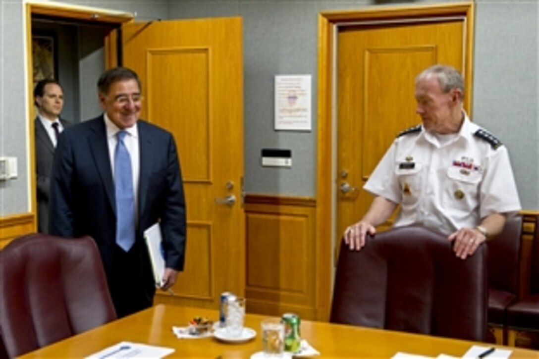 Army Chief of Staff Gen. Martin E. Dempsey, right, greets new Defense Secretary Leon E. Panetta, left, during his first visit to "The Tank" to meet with the Joint Chiefs at the Pentagon, July 1, 2011.